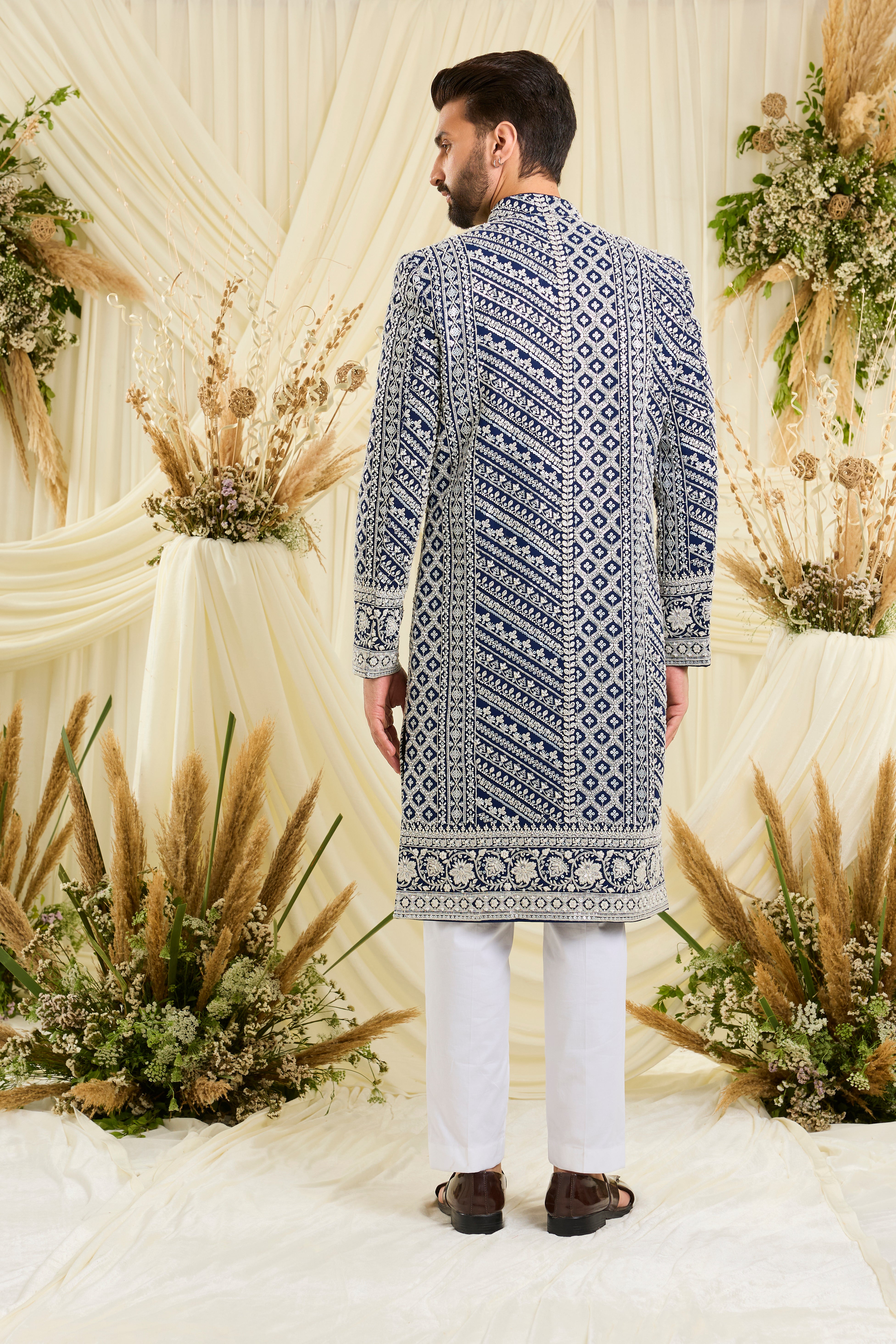 Royal blue sherwani with intricate white cut dana work and delicate sequins, crafted for a bold, ultra-luxurious statement.