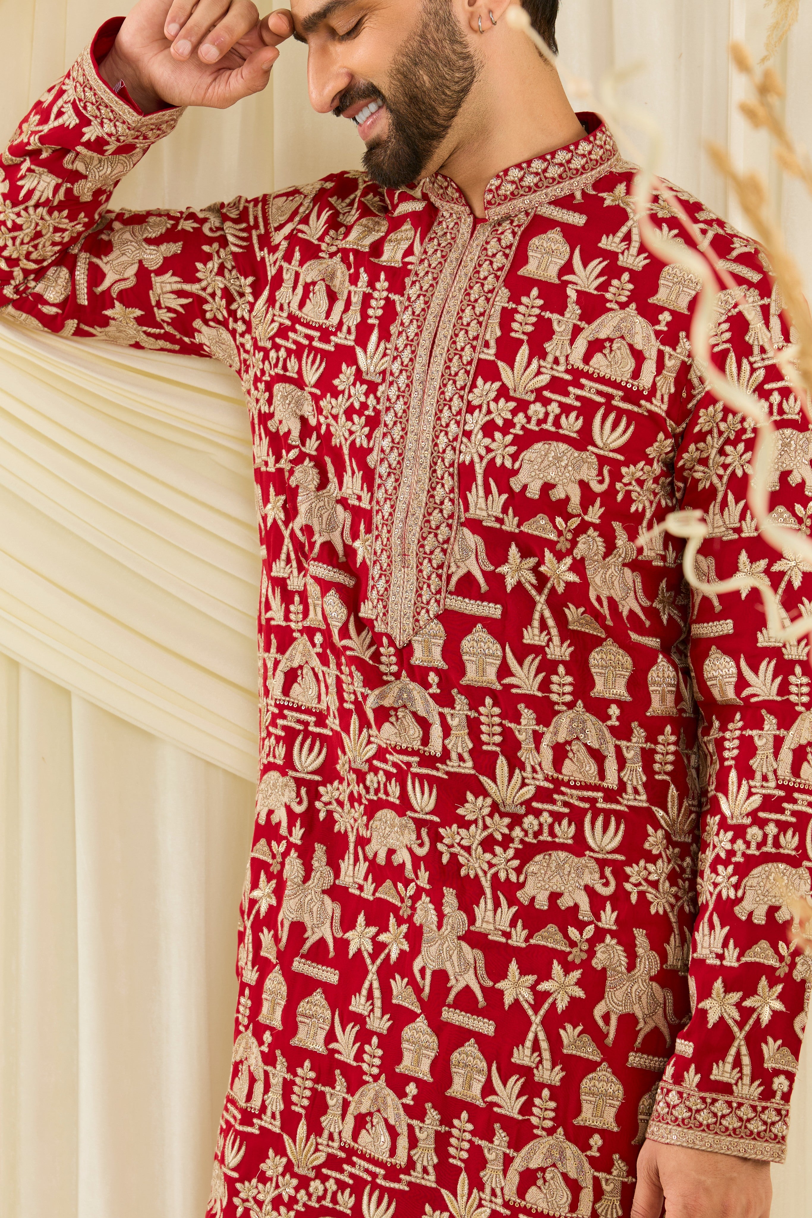 Red-pink Mughal era kurta with heavy zari work and a delicate neckline — regal, opulent, and timelessly refined