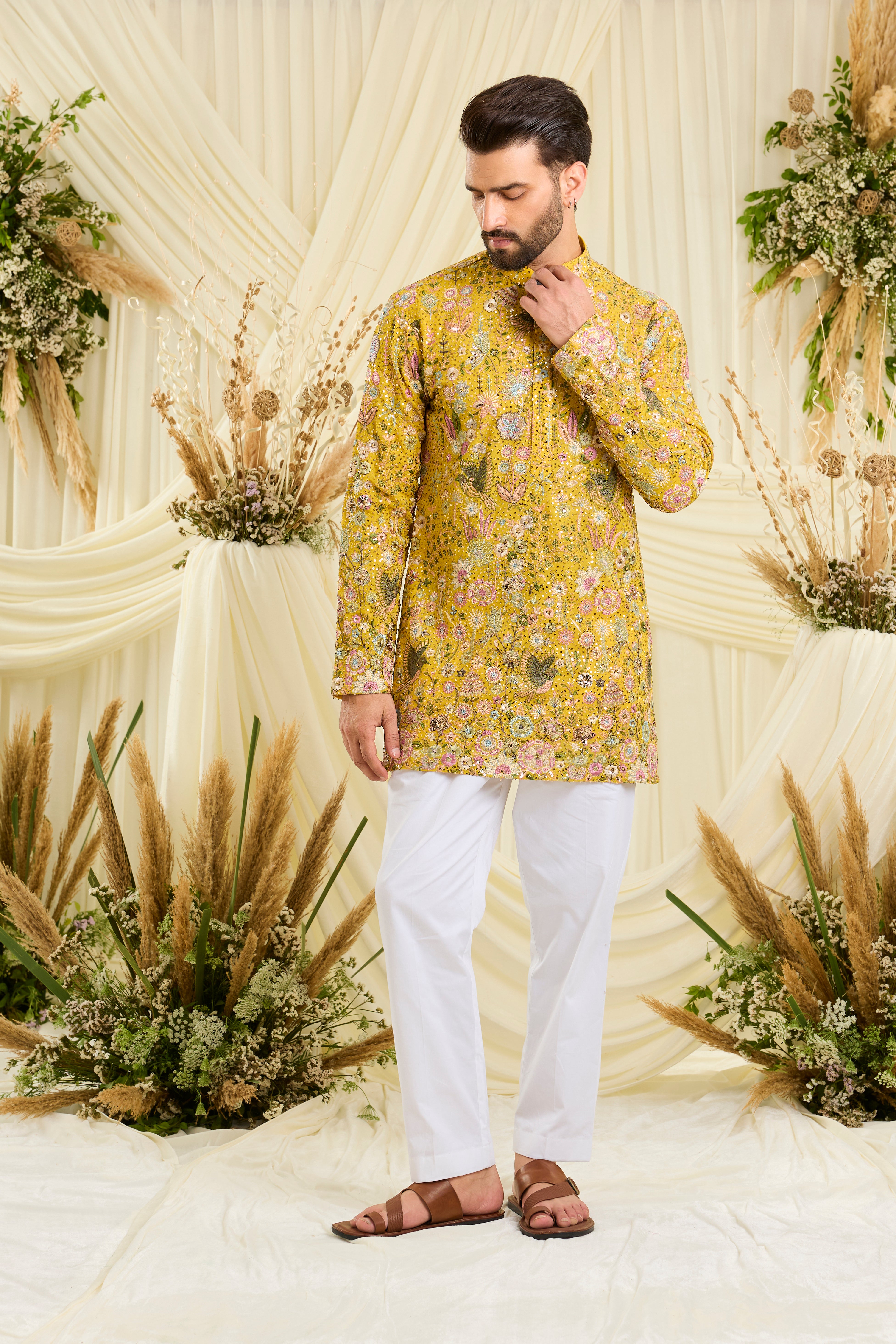 Yellow sequined short kurta with intricate flora-fauna embroidery, multicolour threadwork, and detailed sequins for a fresh, elevated festive look.