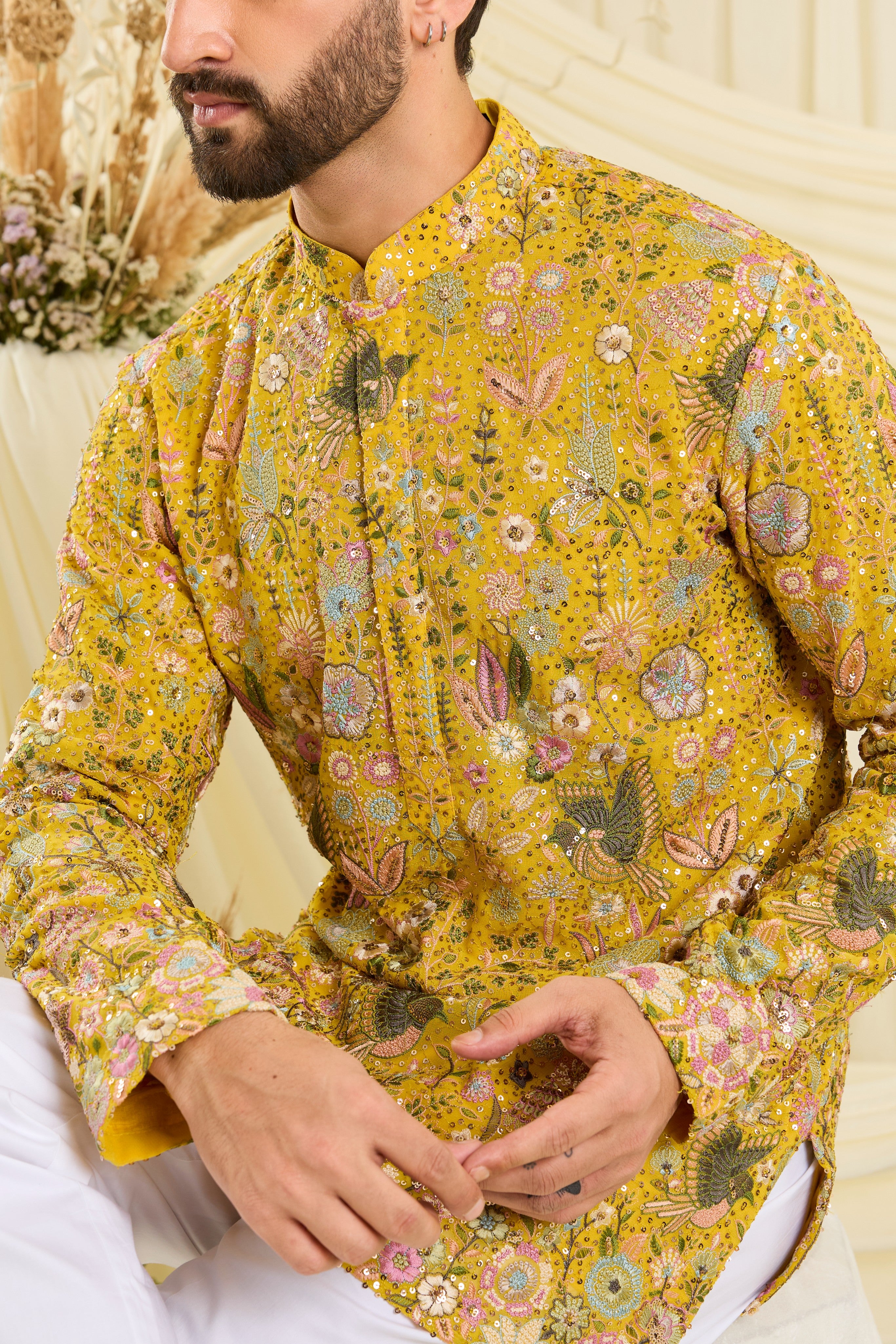 Yellow sequined short kurta with intricate flora-fauna embroidery, multicolour threadwork, and detailed sequins for a fresh, elevated festive look.