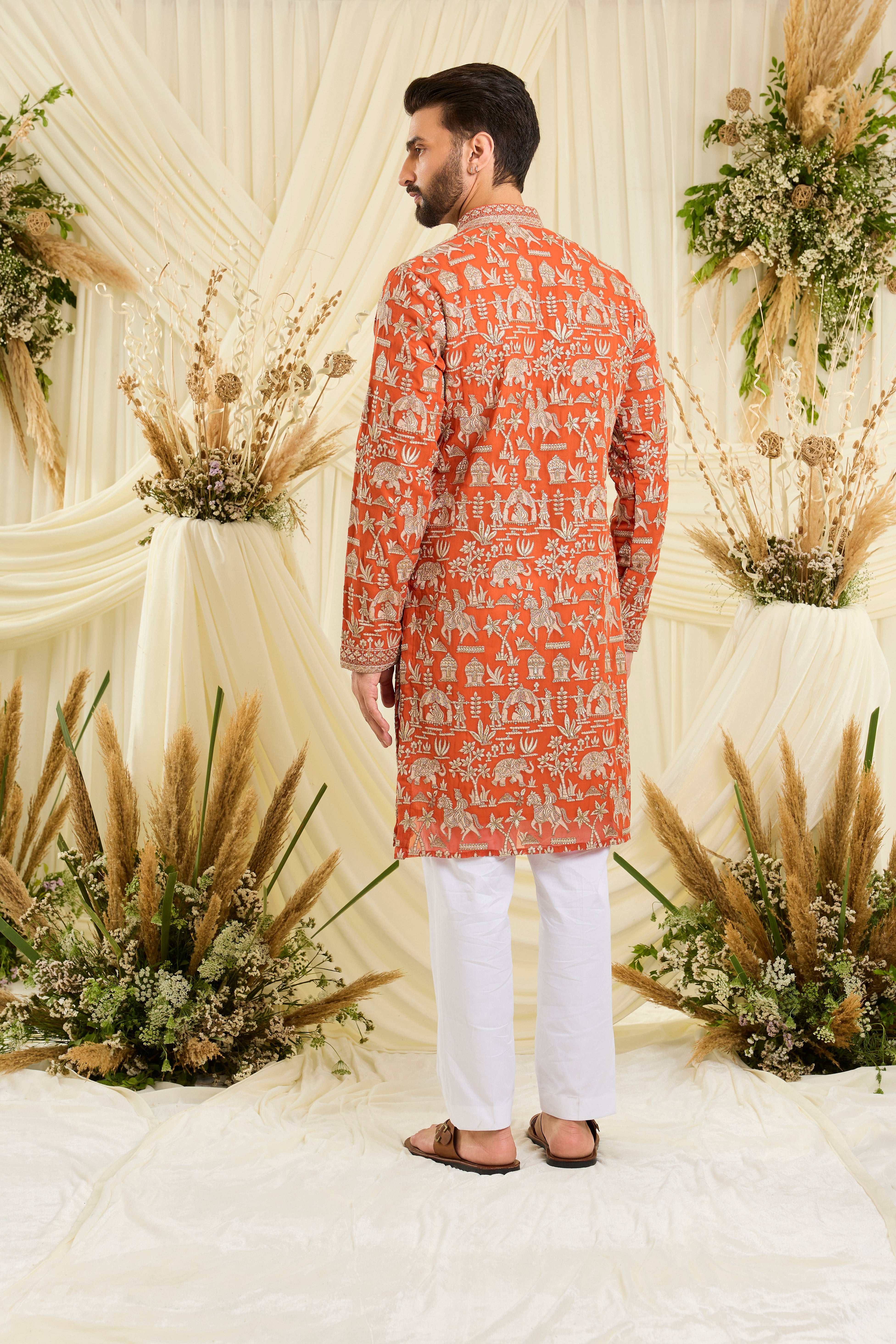 Orange Mughal era kurta with heavy zari work and a delicate neckline — regal, opulent, and timelessly refined