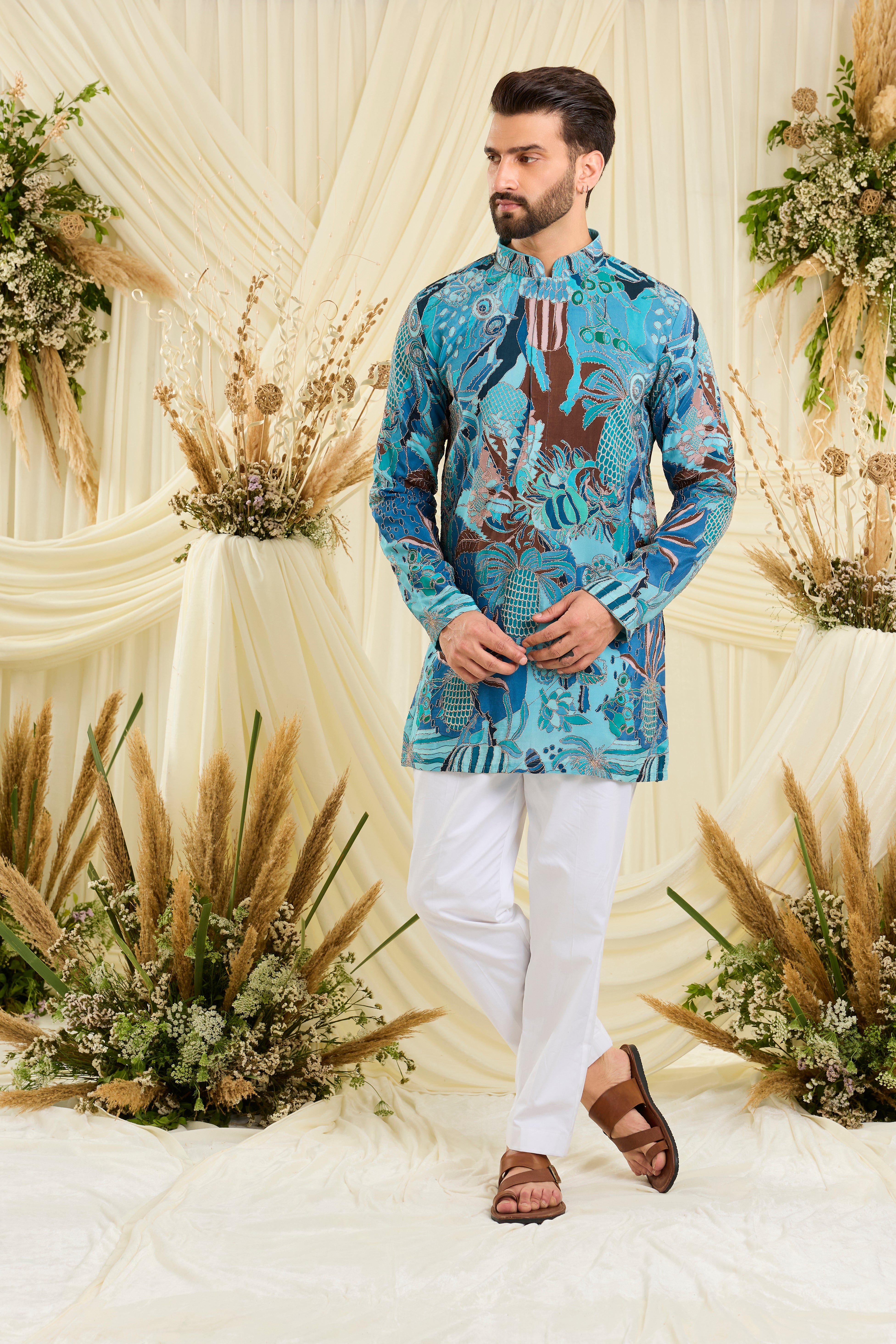Blue abstract short kurta with multicolour prints and zari detailing — artistic, vibrant, and effortlessly luxurious.