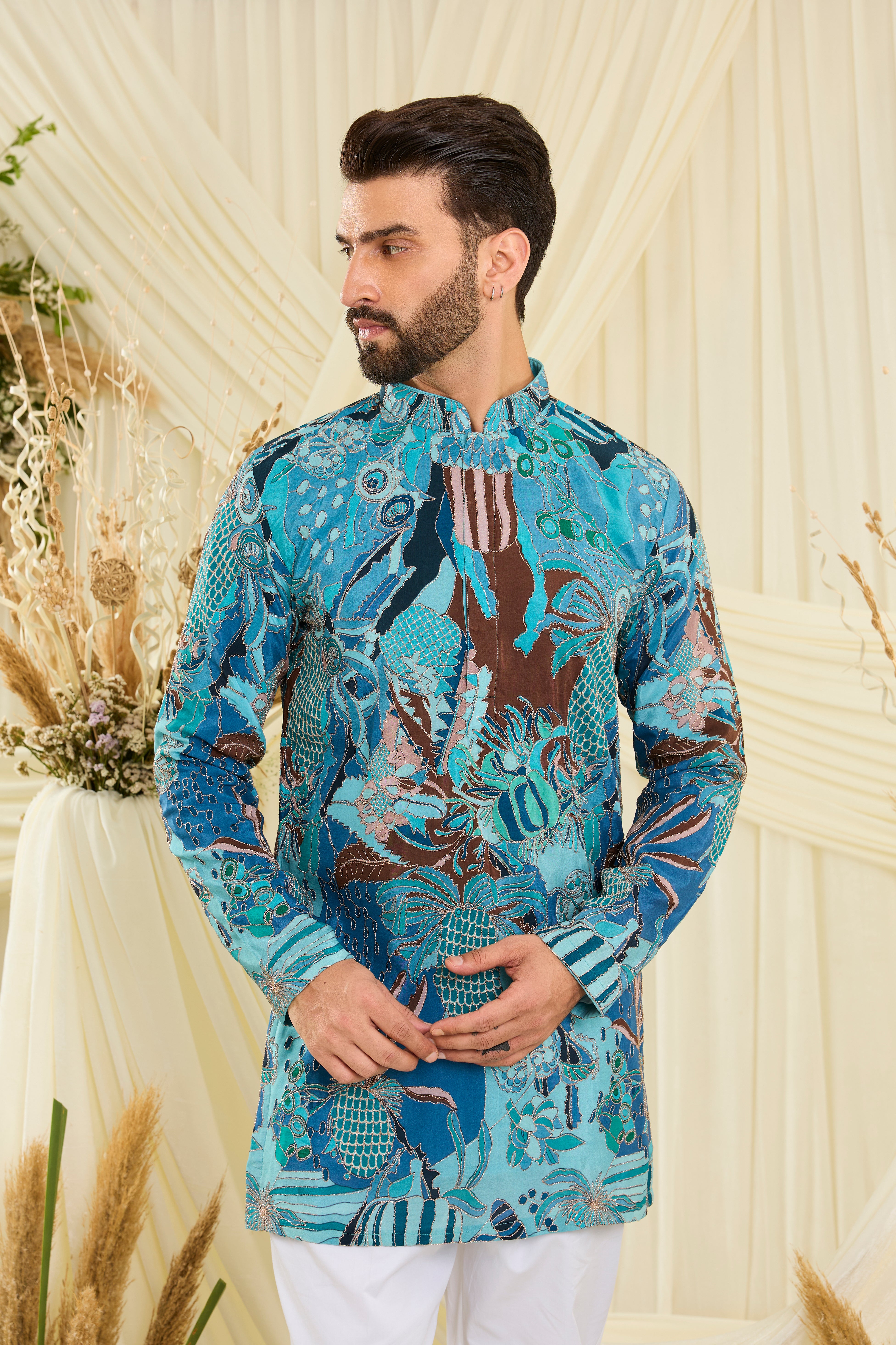 Blue abstract short kurta with multicolour prints and zari detailing — artistic, vibrant, and effortlessly luxurious.