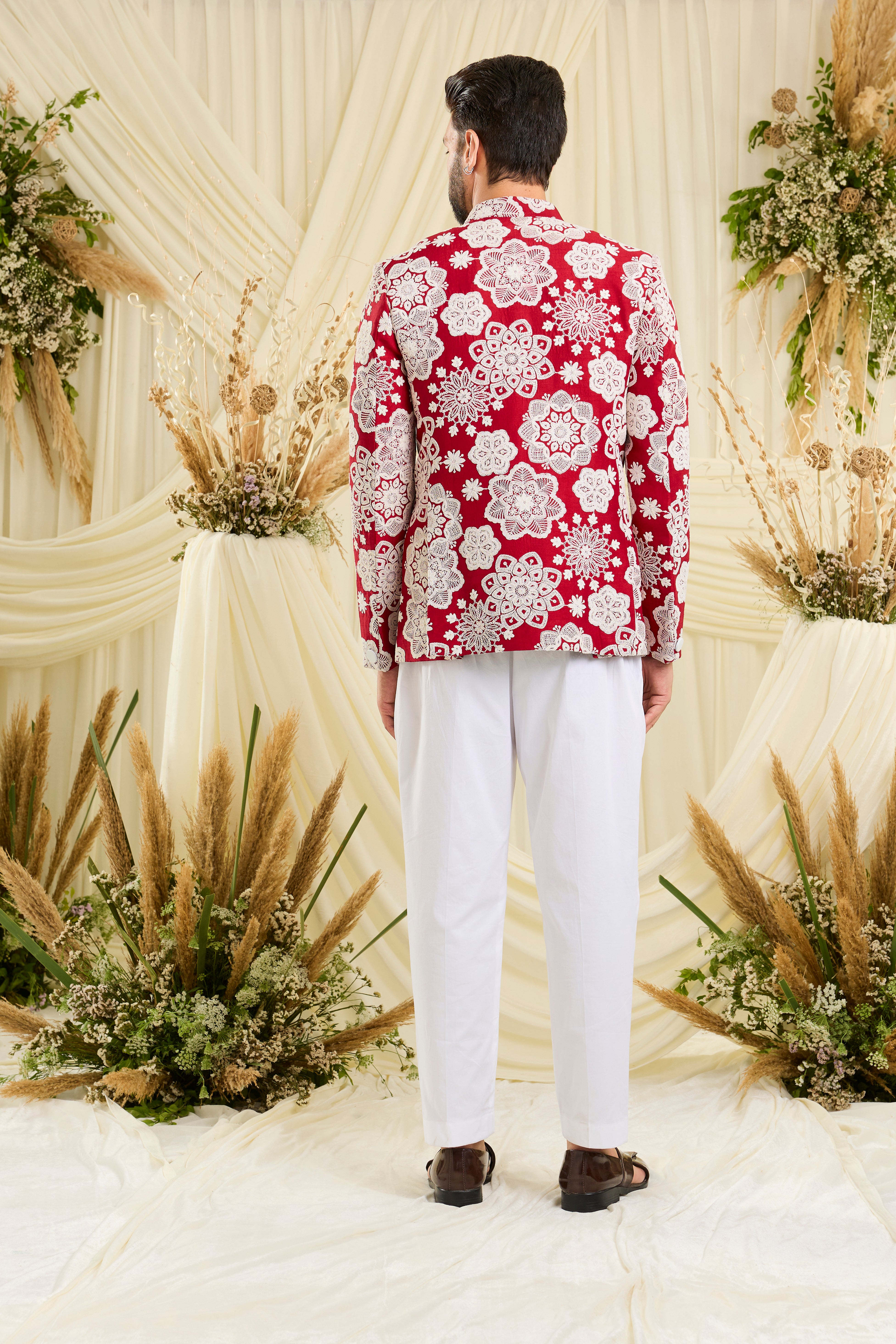 Red bandgala with intricate floral embroidery and heavy dori work, delivering a richly textured, bold festive statement.