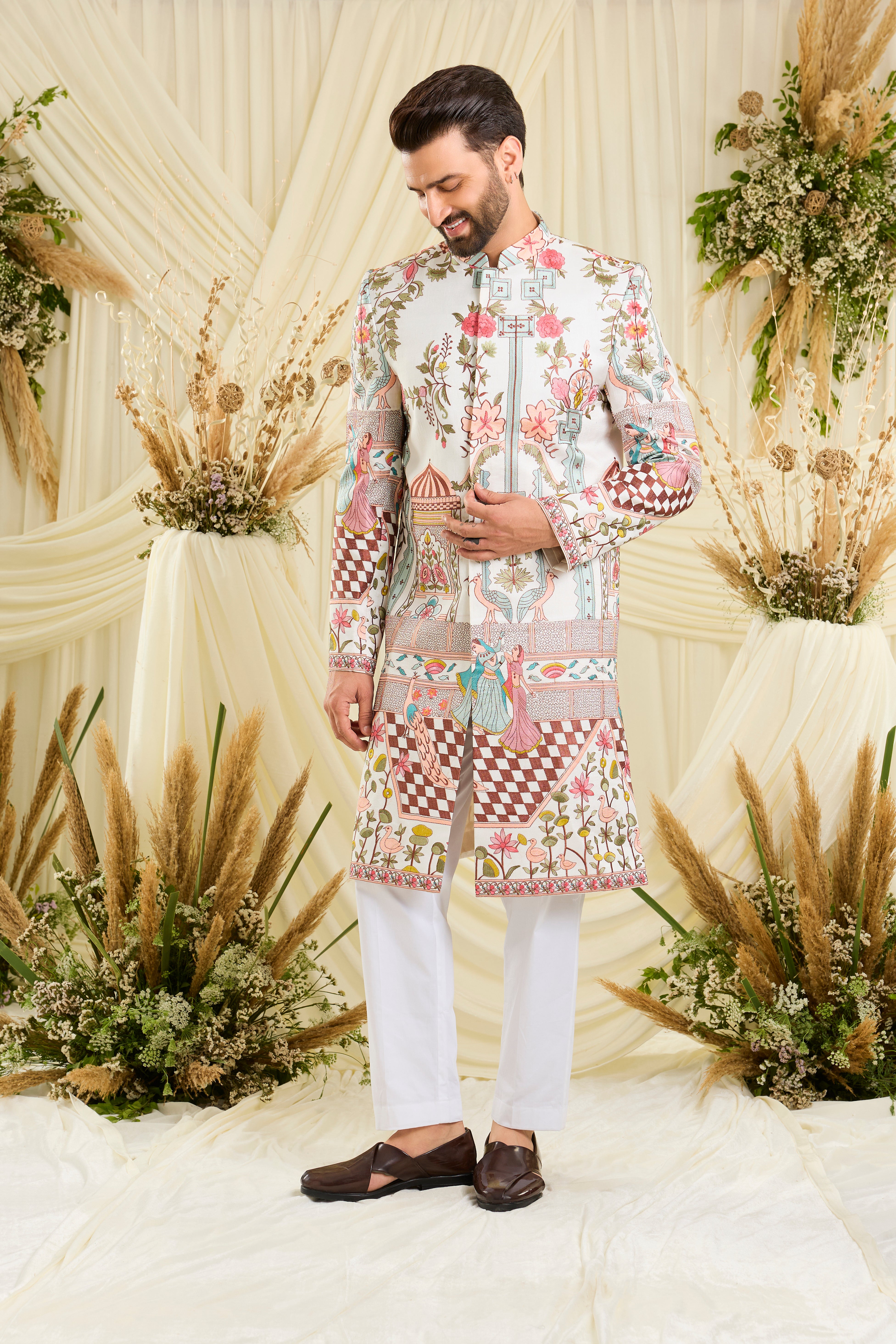 Opulent silk sherwani with Mughal darbars, peacocks, florals, and dancing royals — a masterpiece of imperial artistry.