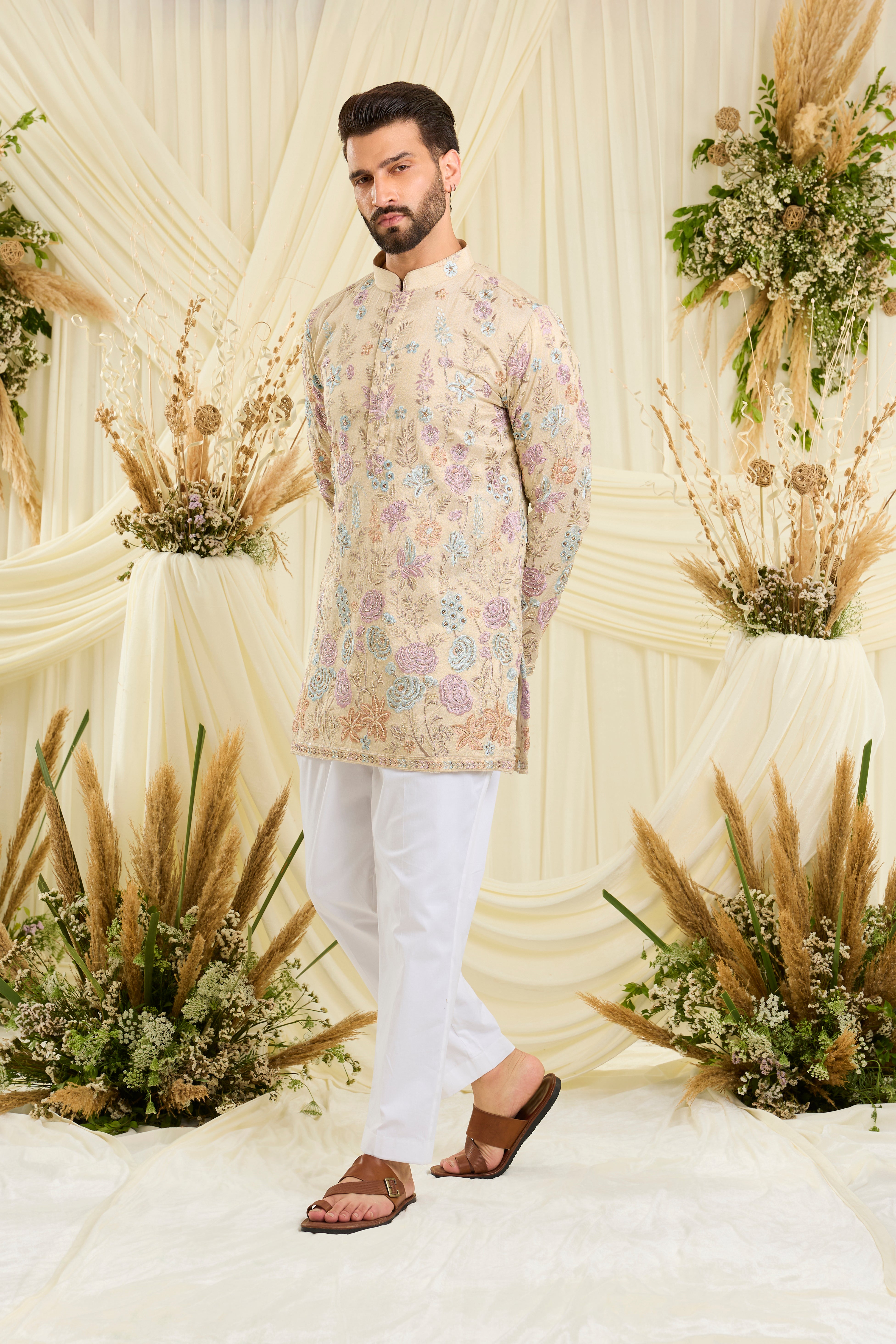 Cream-gold short kurta with floral embroidery, multicolour threadwork, and cut dana detailing — regal, luminous, and effortlessly sophisticated.