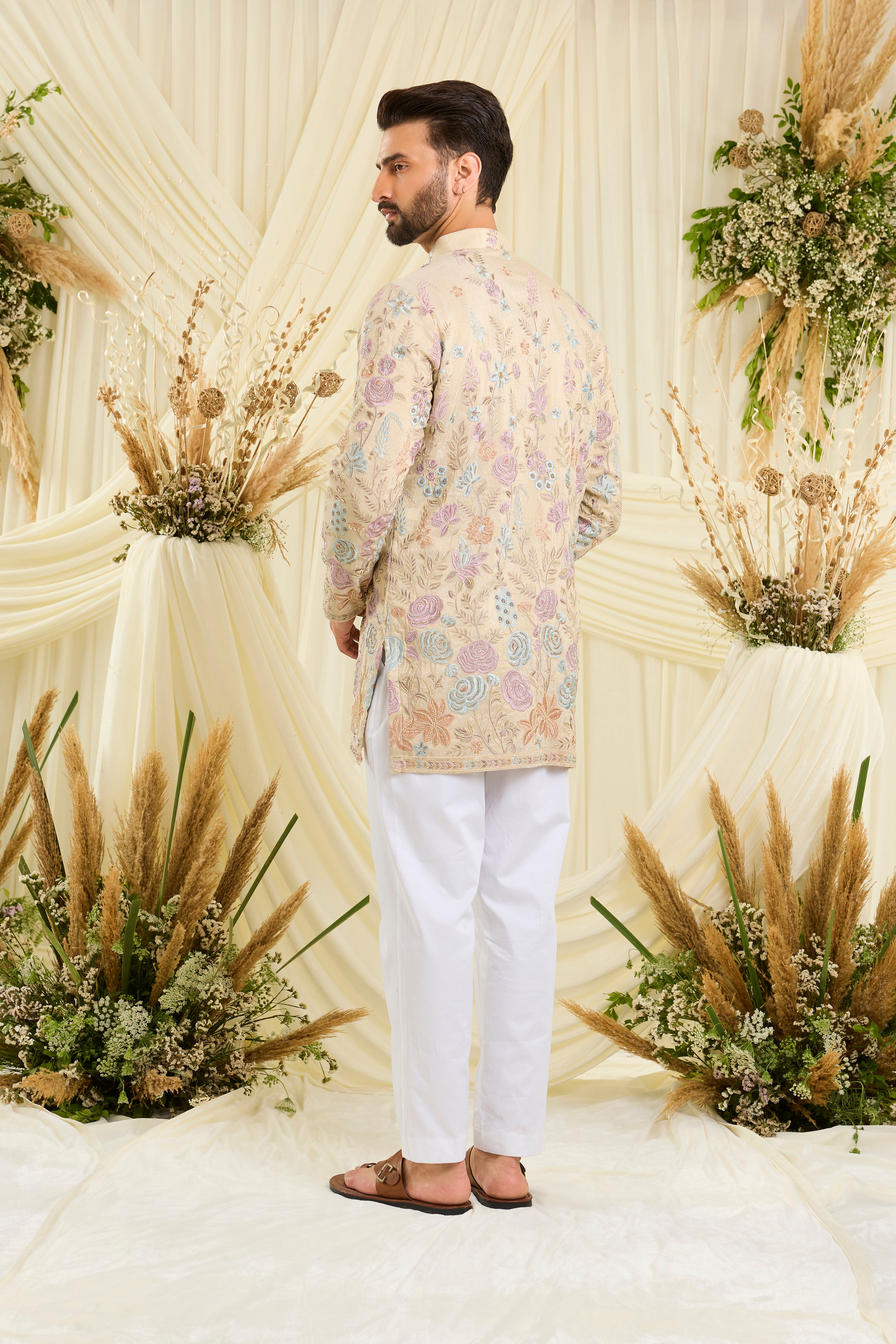 Cream-gold short kurta with floral embroidery, multicolour threadwork, and cut dana detailing — regal, luminous, and effortlessly sophisticated.