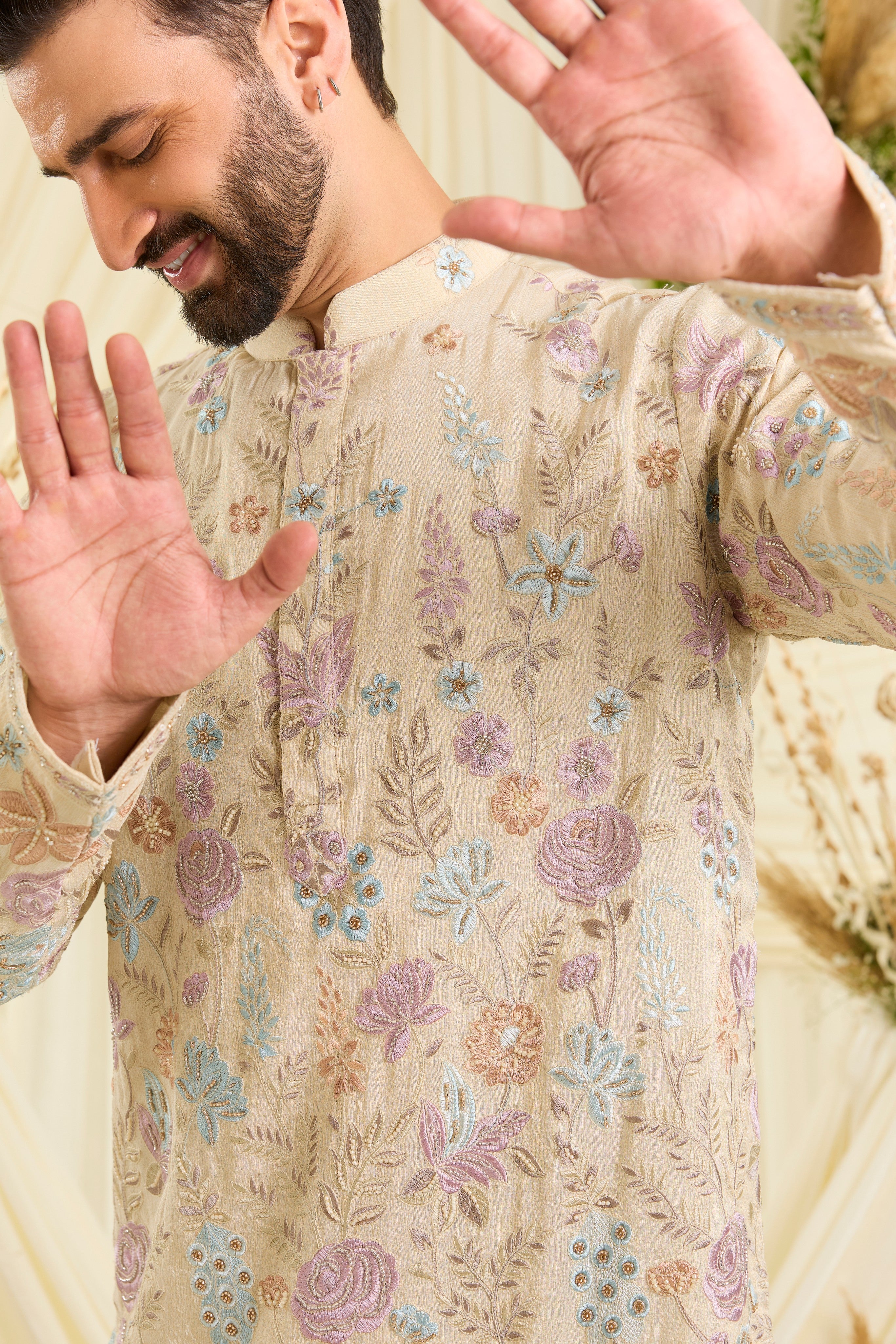 Cream-gold short kurta with floral embroidery, multicolour threadwork, and cut dana detailing — regal, luminous, and effortlessly sophisticated.