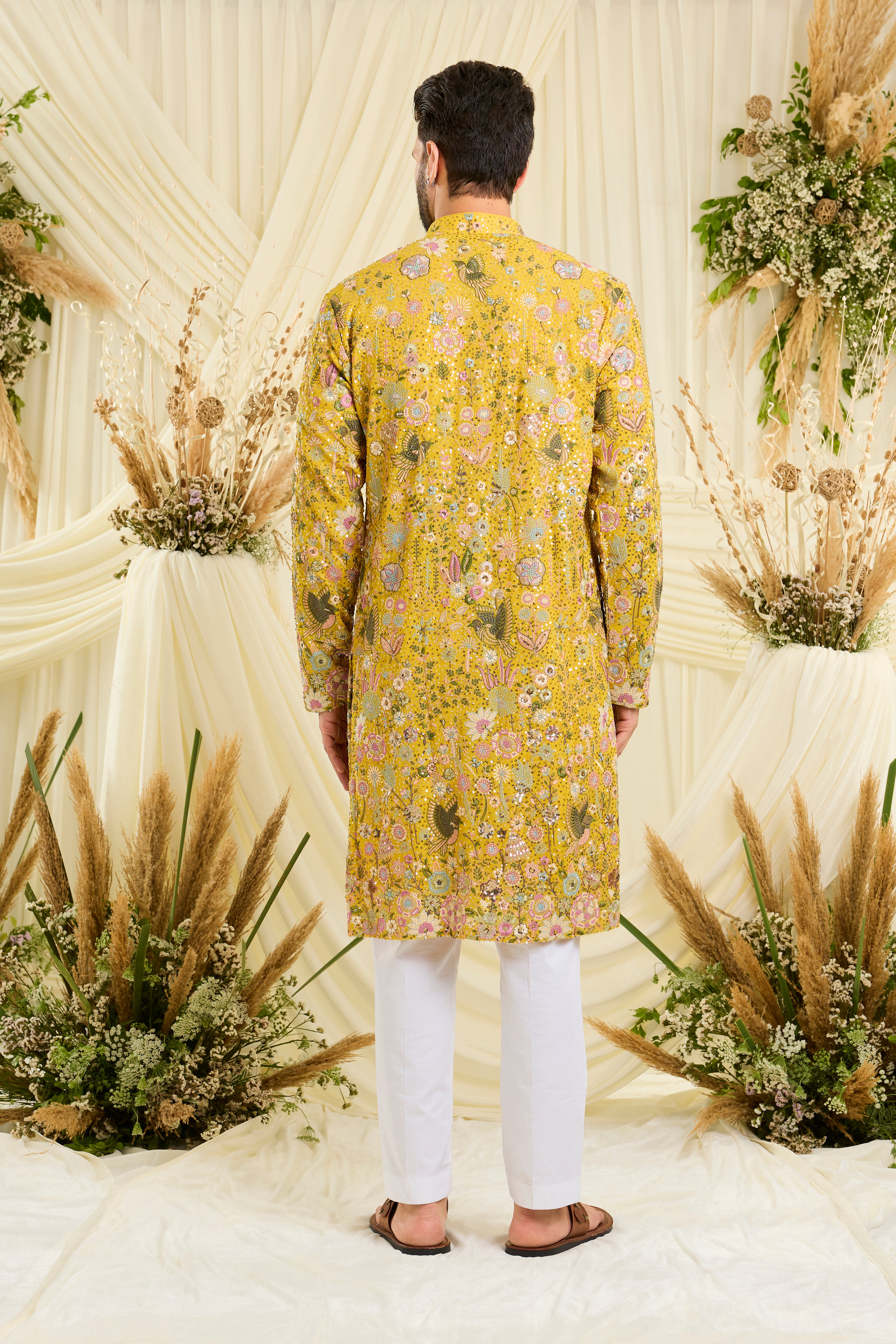 Yellow sequined kurta with intricate flora-fauna embroidery, multicolour threadwork, and detailed sequins for a fresh, elevated festive look.