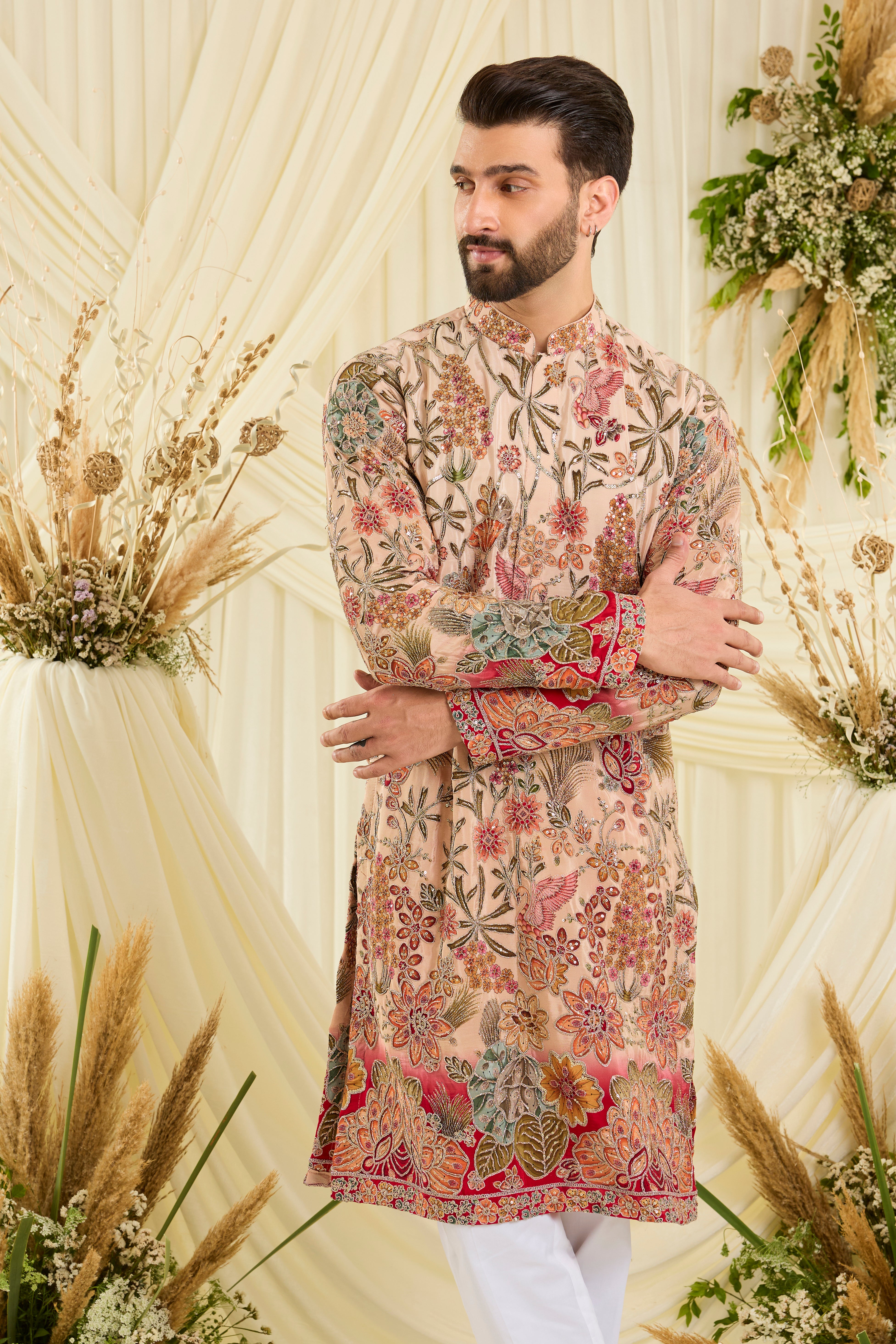 Pastel peach kurta with intricate floral embroidery, rich zari detailing, and delicate sequins for a refined, luminous festive statement.