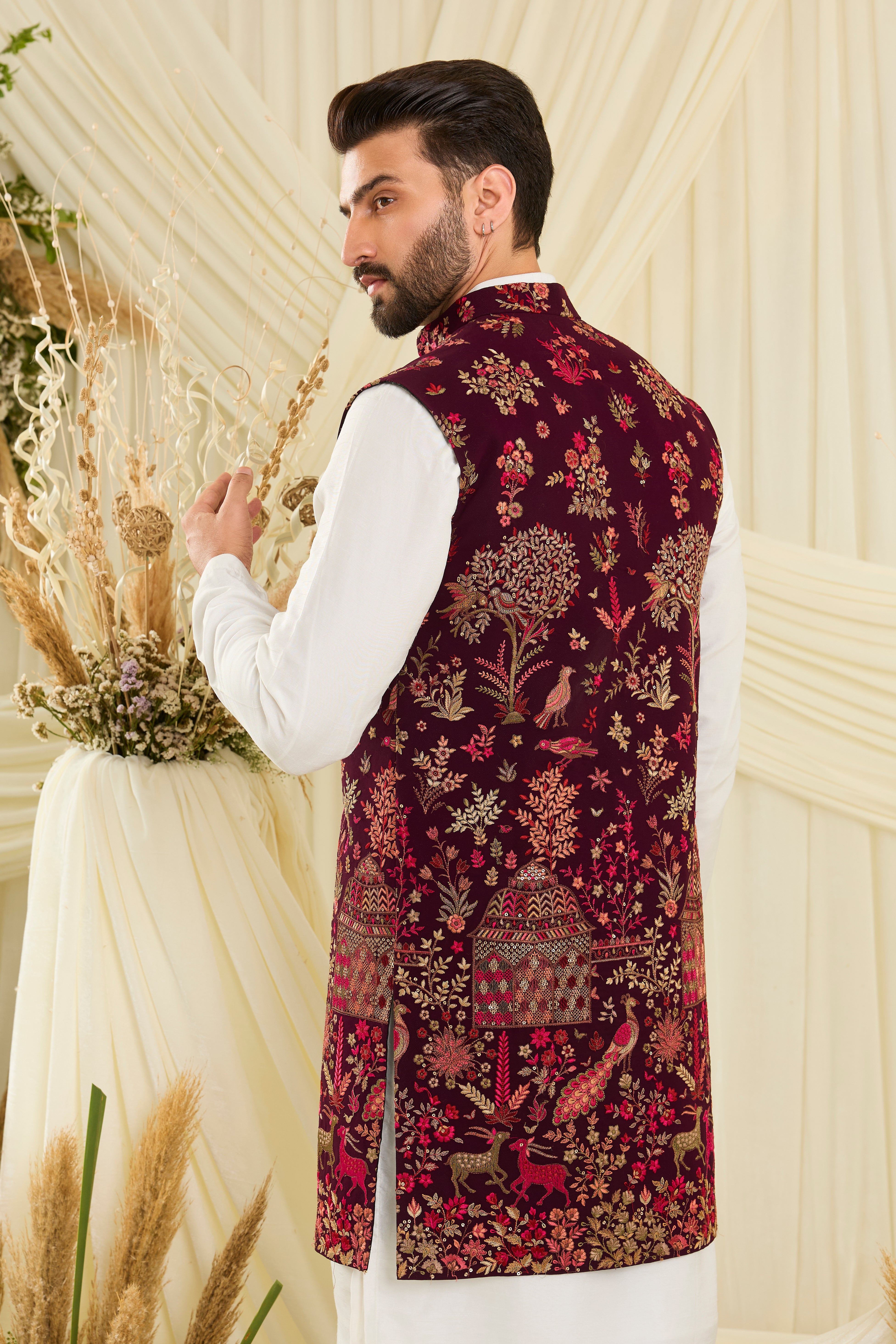 Wine / maroon long open jacket with intricate flora-fauna embroidery, multicolour threadwork, and delicate sequins for a fresh, elevated festive look.
