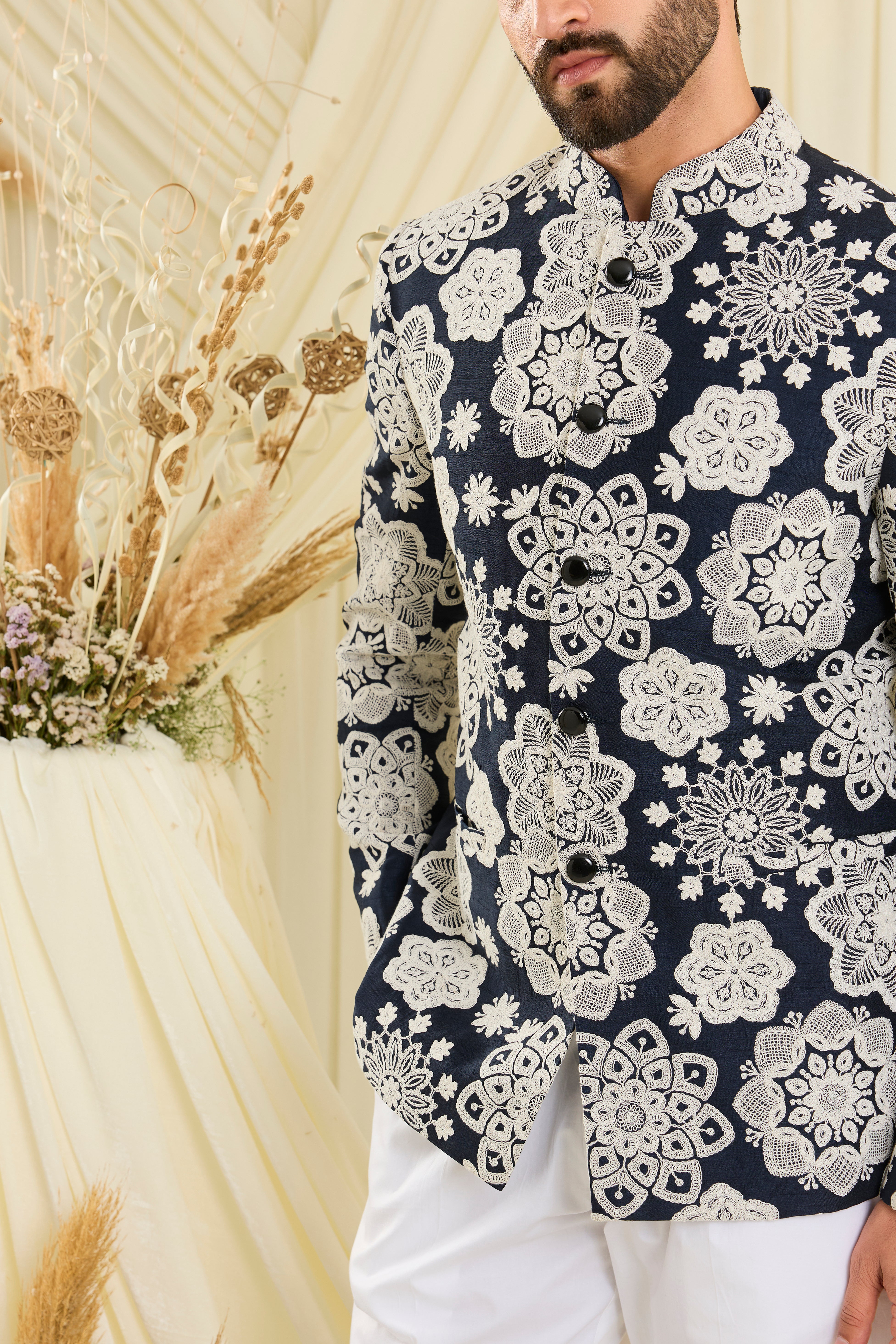Red bandgala with intricate floral embroidery and heavy dori work, delivering a richly textured, bold festive statement.