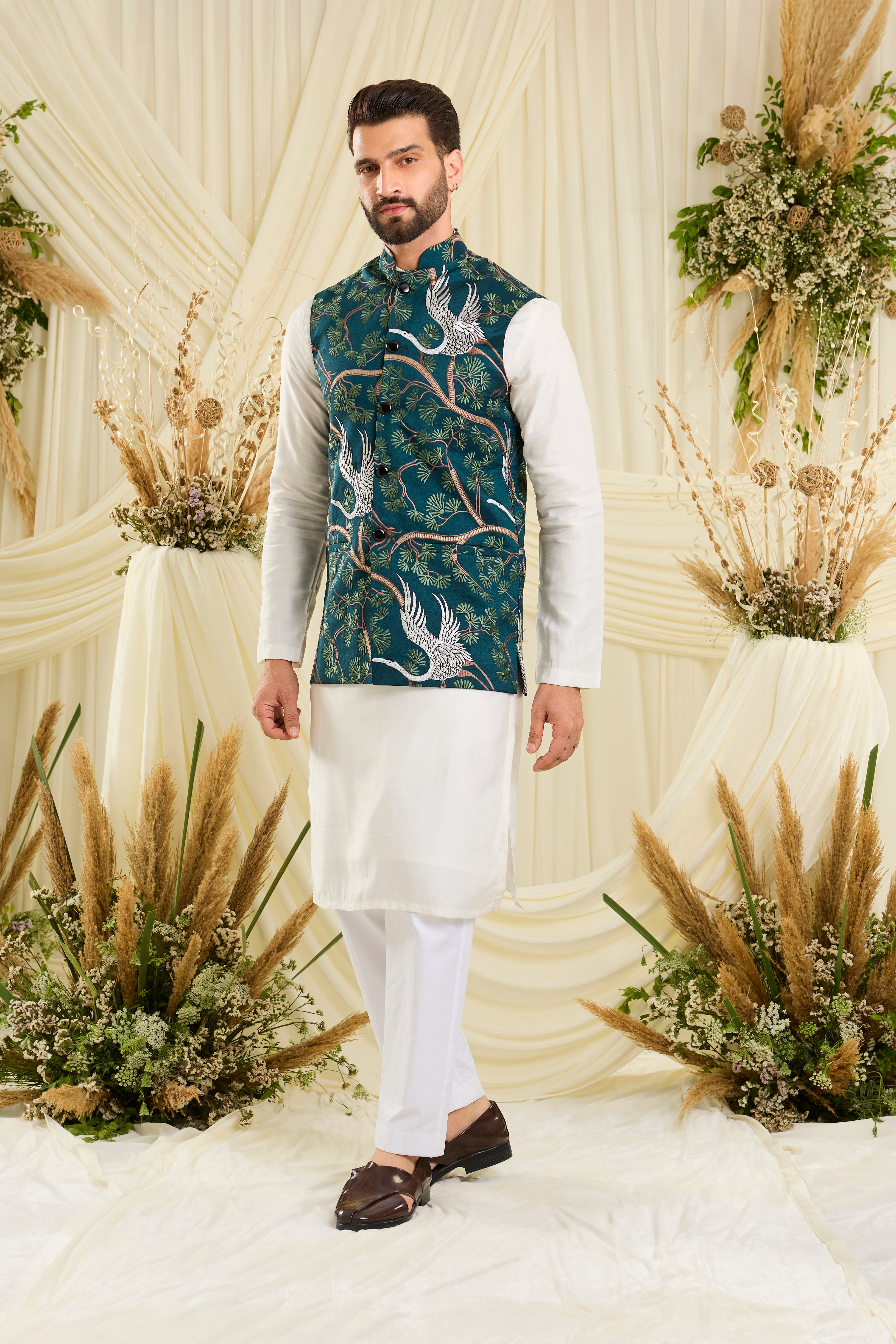 Teal Nehru jacket with intricate floral patterns and elegant white flamingo motifs, blending artistic charm with refined sophistication.