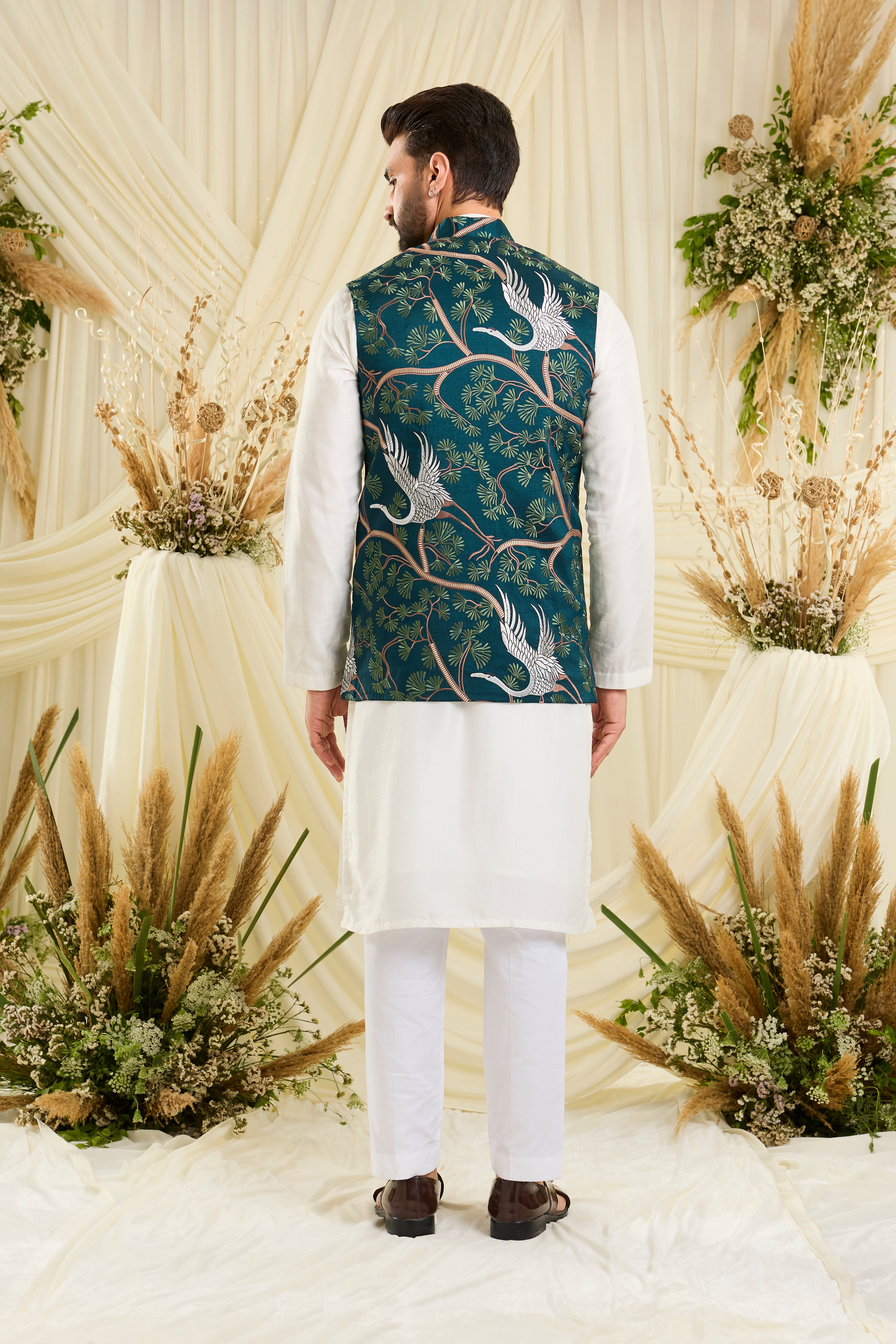 Teal Nehru jacket with intricate floral patterns and elegant white flamingo motifs, blending artistic charm with refined sophistication.