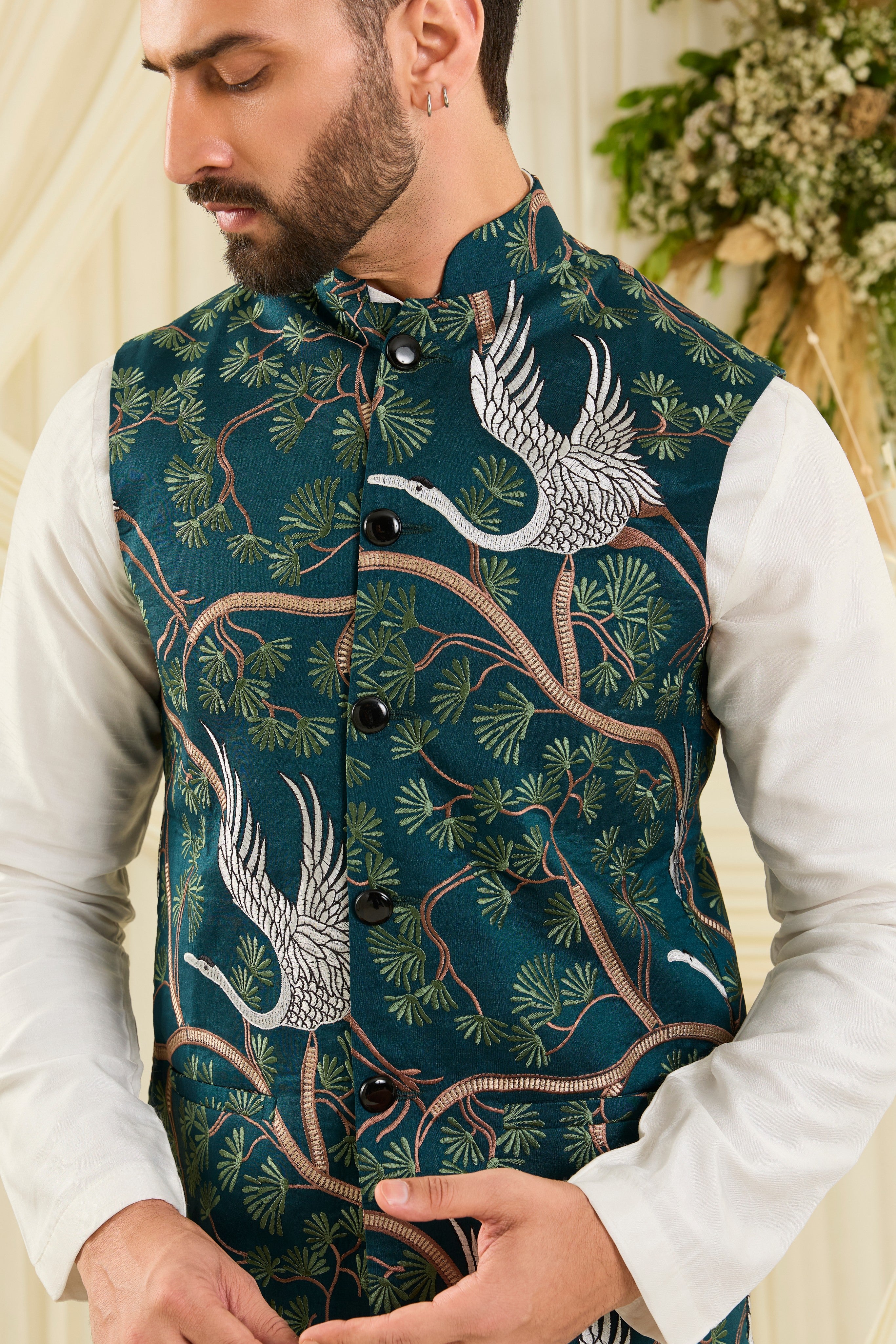 Teal Nehru jacket with intricate floral patterns and elegant white flamingo motifs, blending artistic charm with refined sophistication.