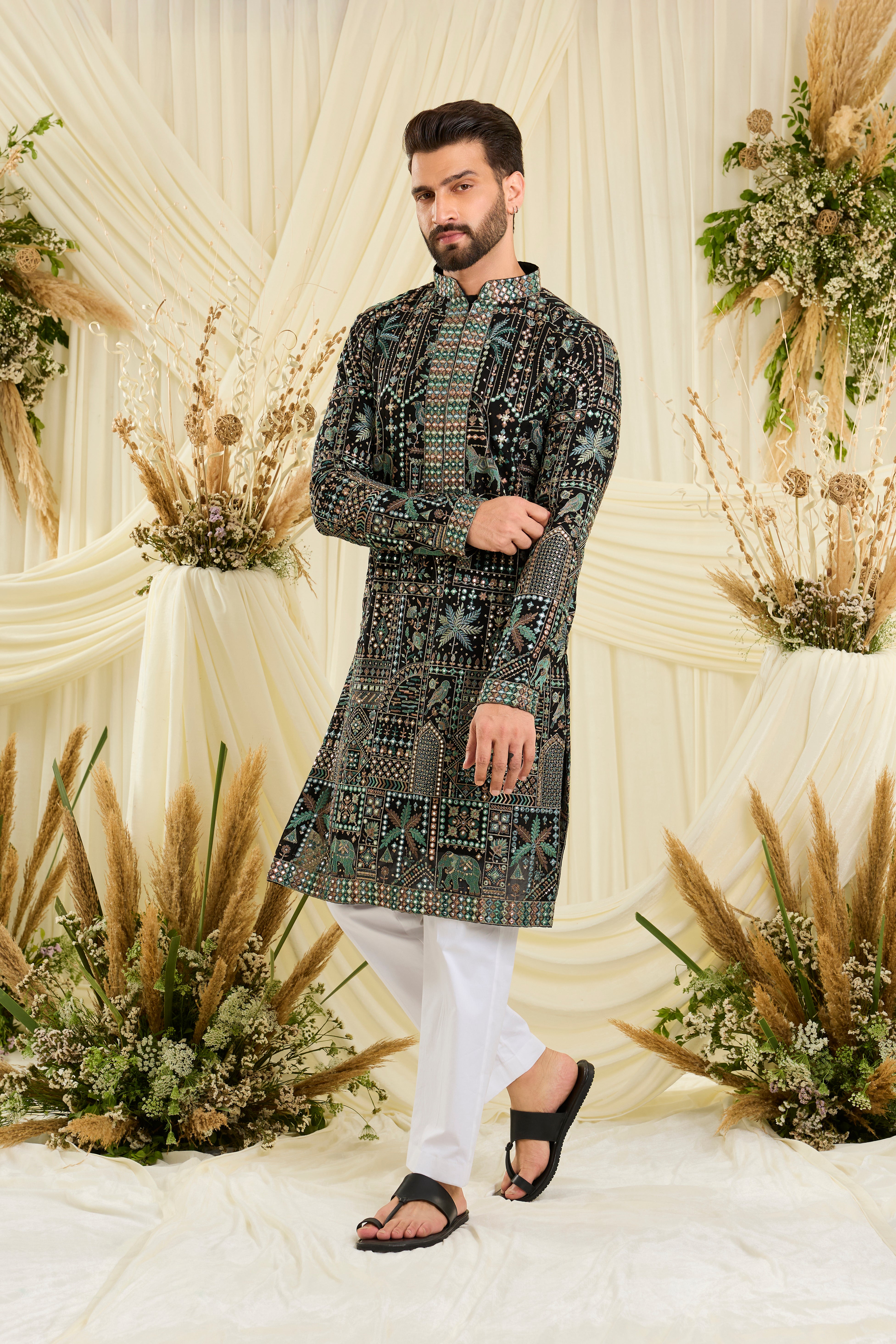 Black kurta with flora-fauna embroidery, multicolour threadwork, and mirror-like sequins — bold, luminous, and effortlessly luxurious.