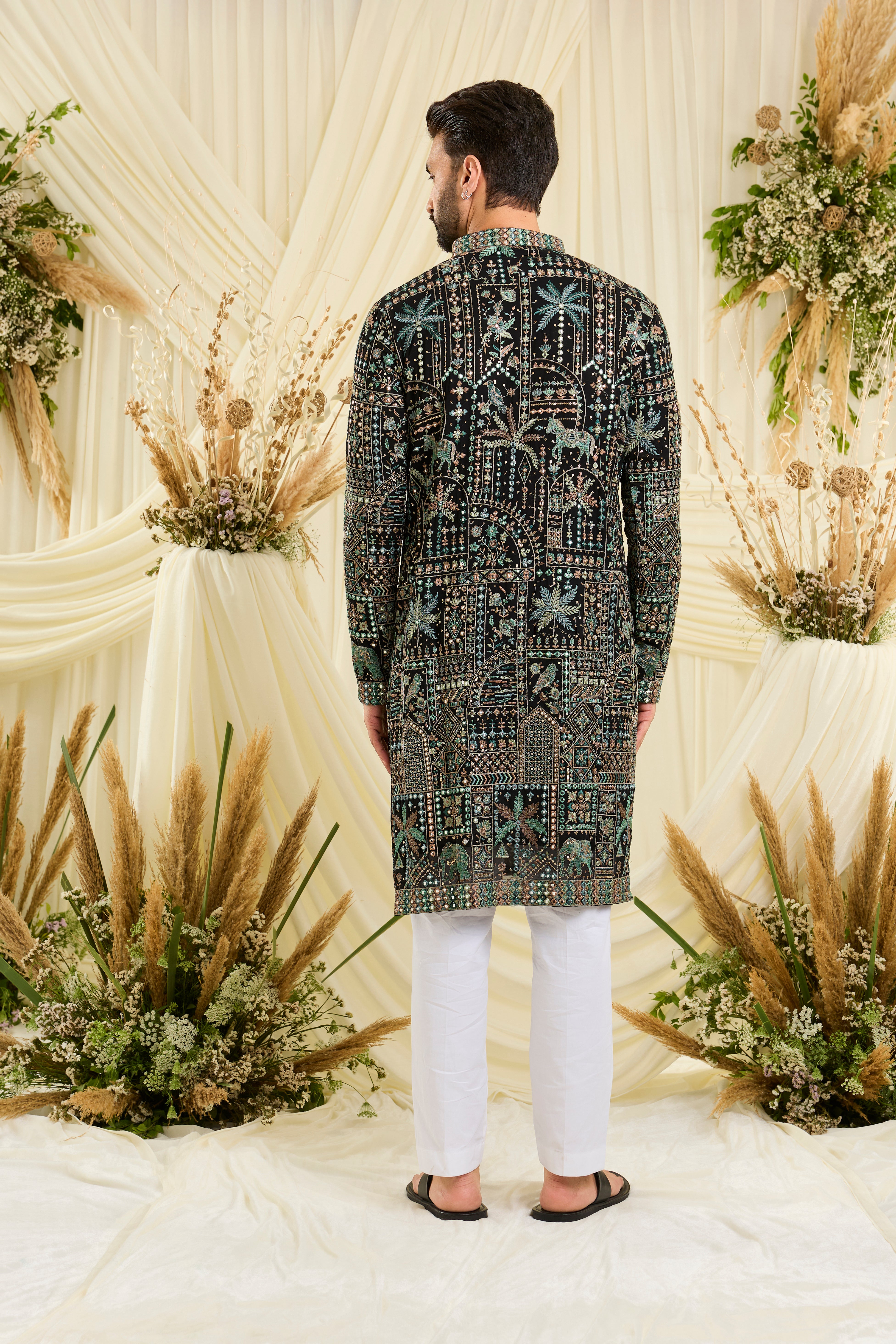 Black kurta with flora-fauna embroidery, multicolour threadwork, and mirror-like sequins — bold, luminous, and effortlessly luxurious.