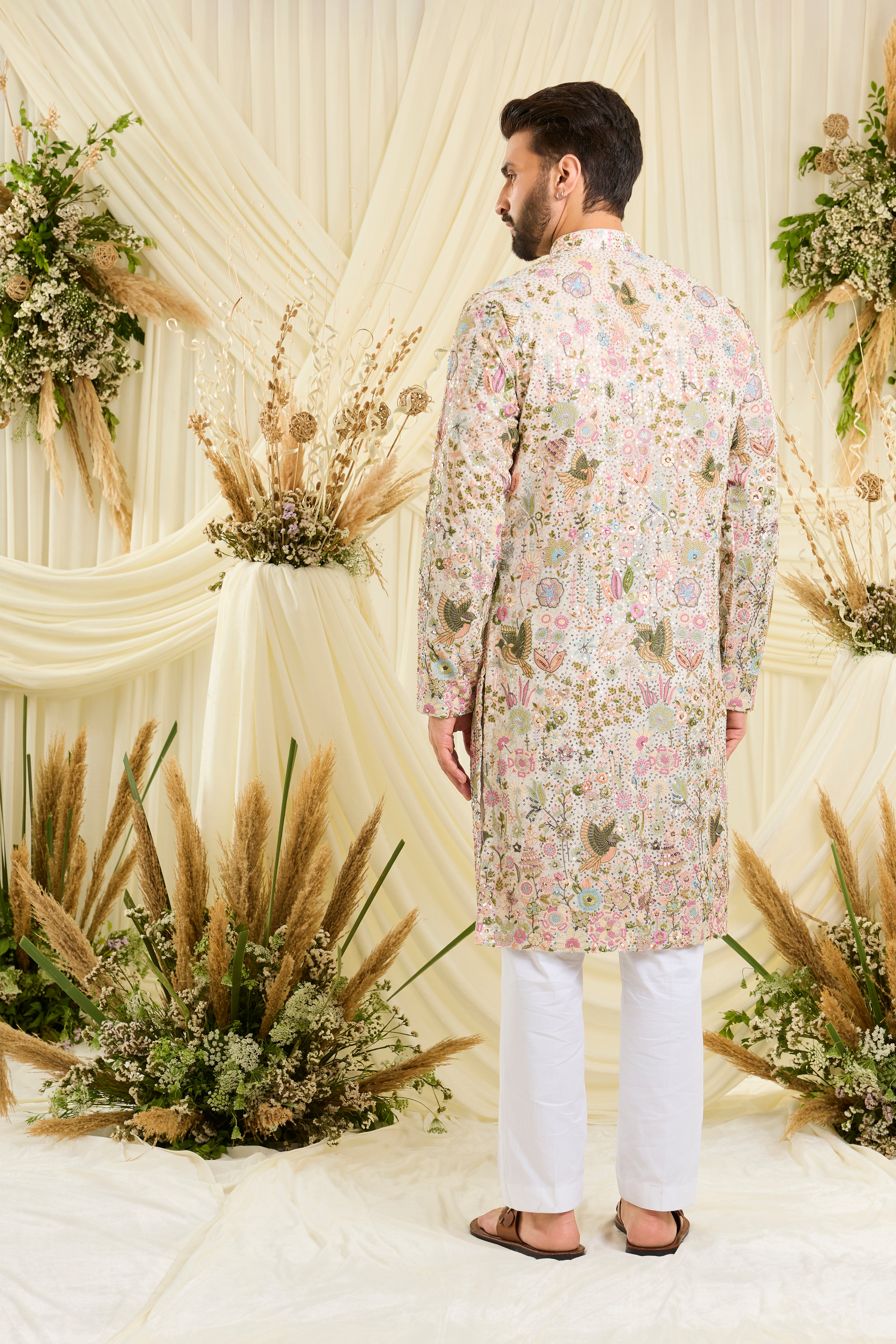 Ivory sequined kurta with intricate flora-fauna embroidery, multicolour threadwork, and detailed sequins for a fresh, elevated festive look.