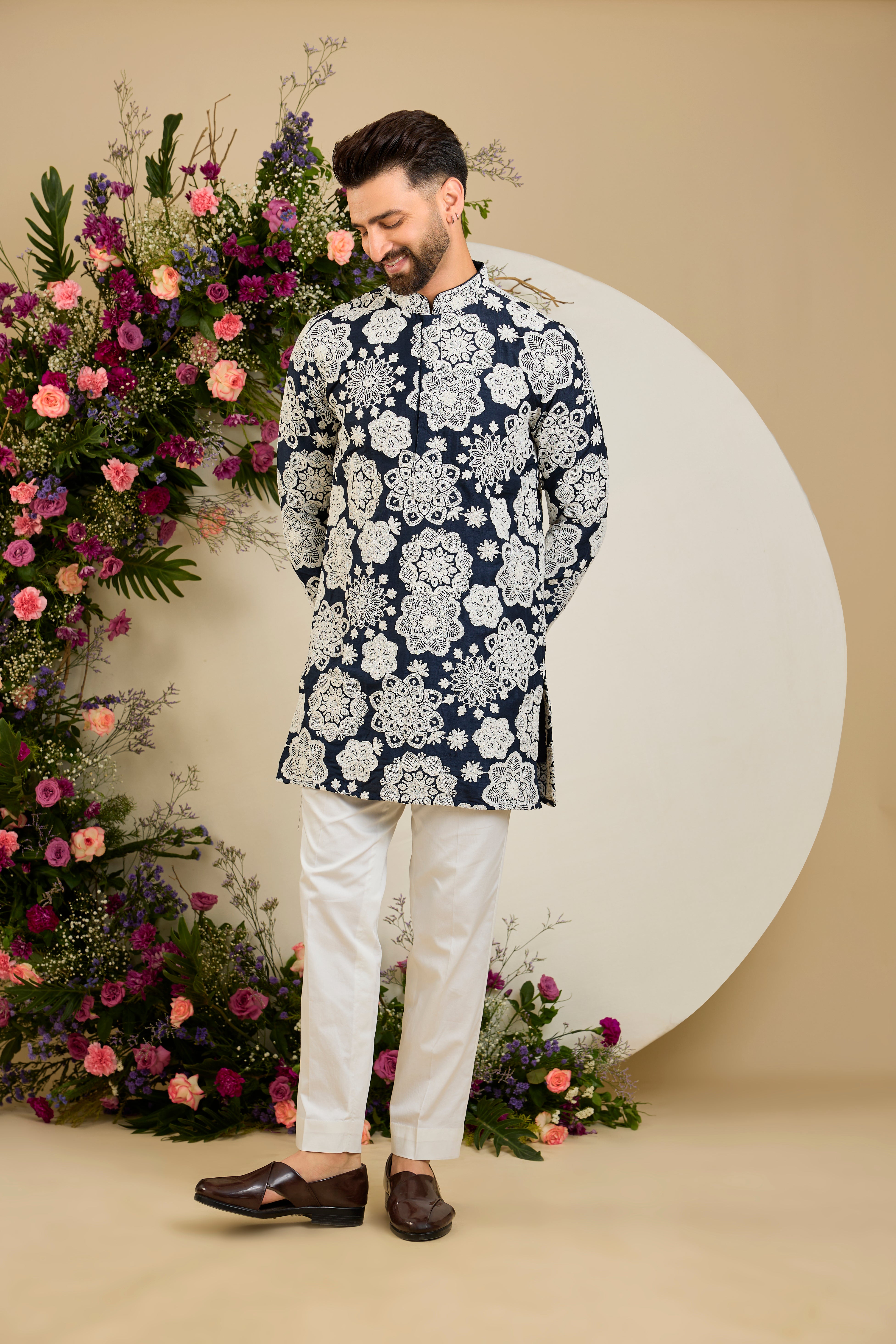 Navy blue silk kurta with radiant floral dori embroidery, tailored for timeless sophistication and distinguished elegance.