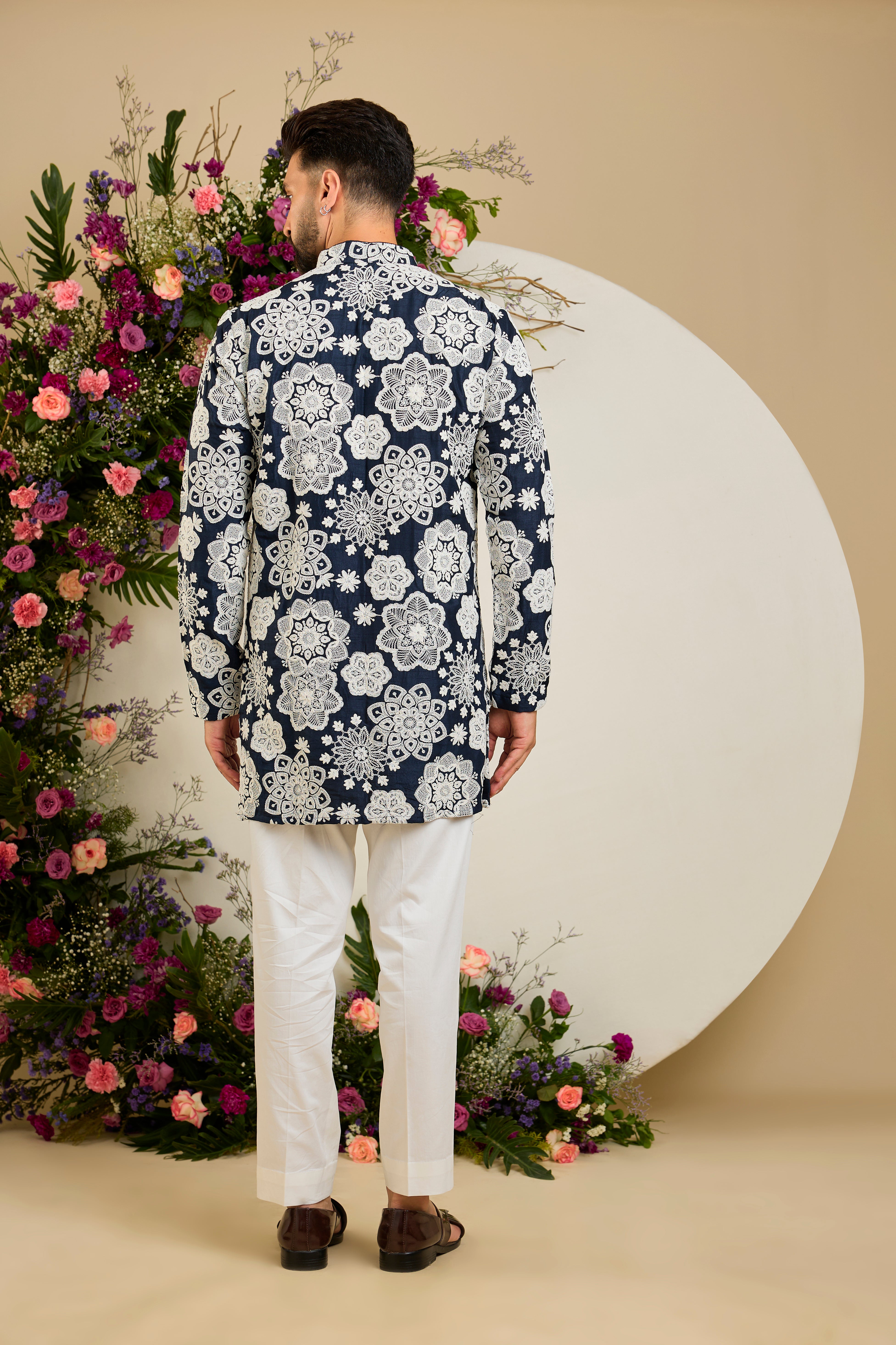 Navy blue silk kurta with radiant floral dori embroidery, tailored for timeless sophistication and distinguished elegance.