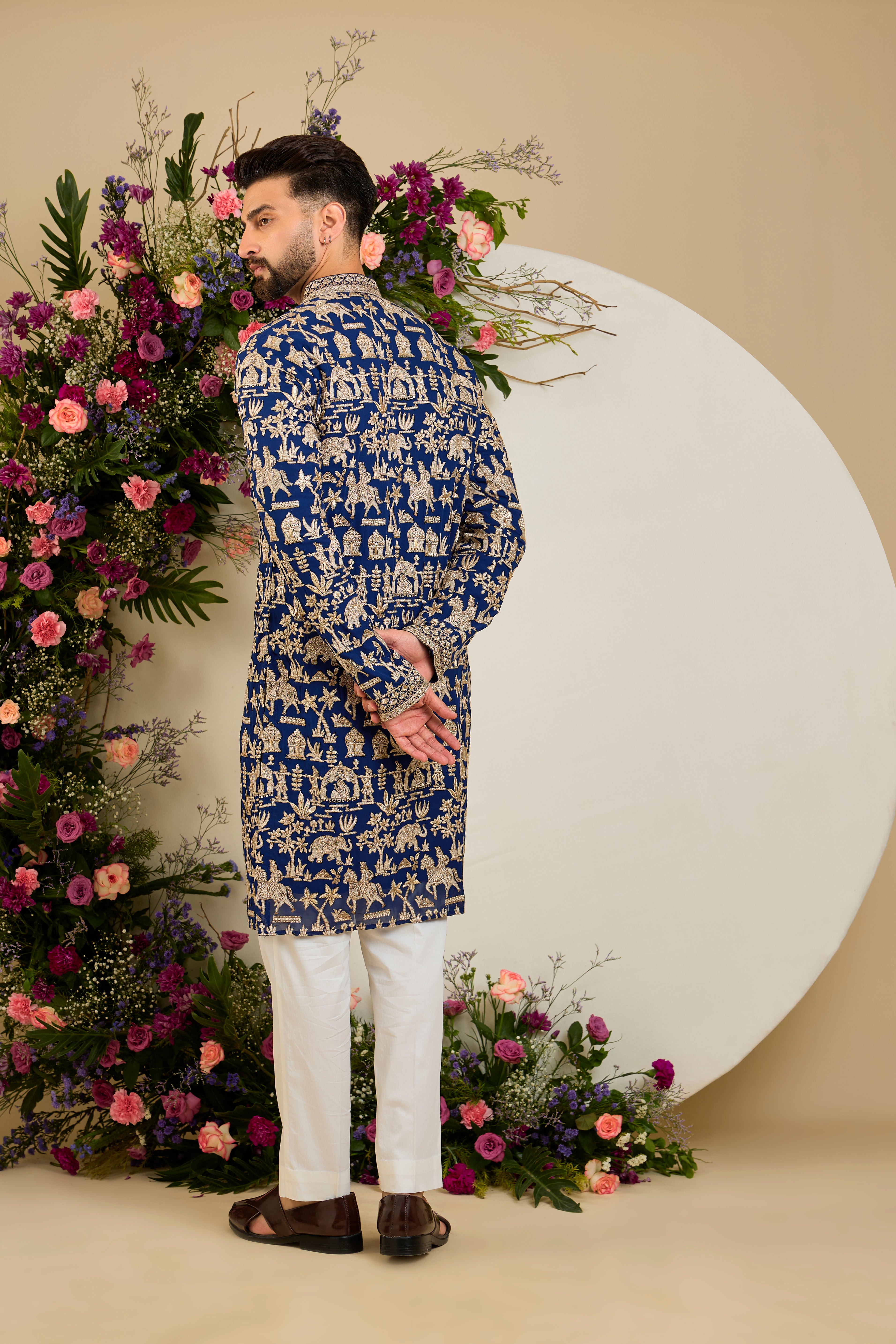Royal blue kurta with Mughal-era embroidery, opulent zari work, sequins, and a refined neckline for timeless grandeur