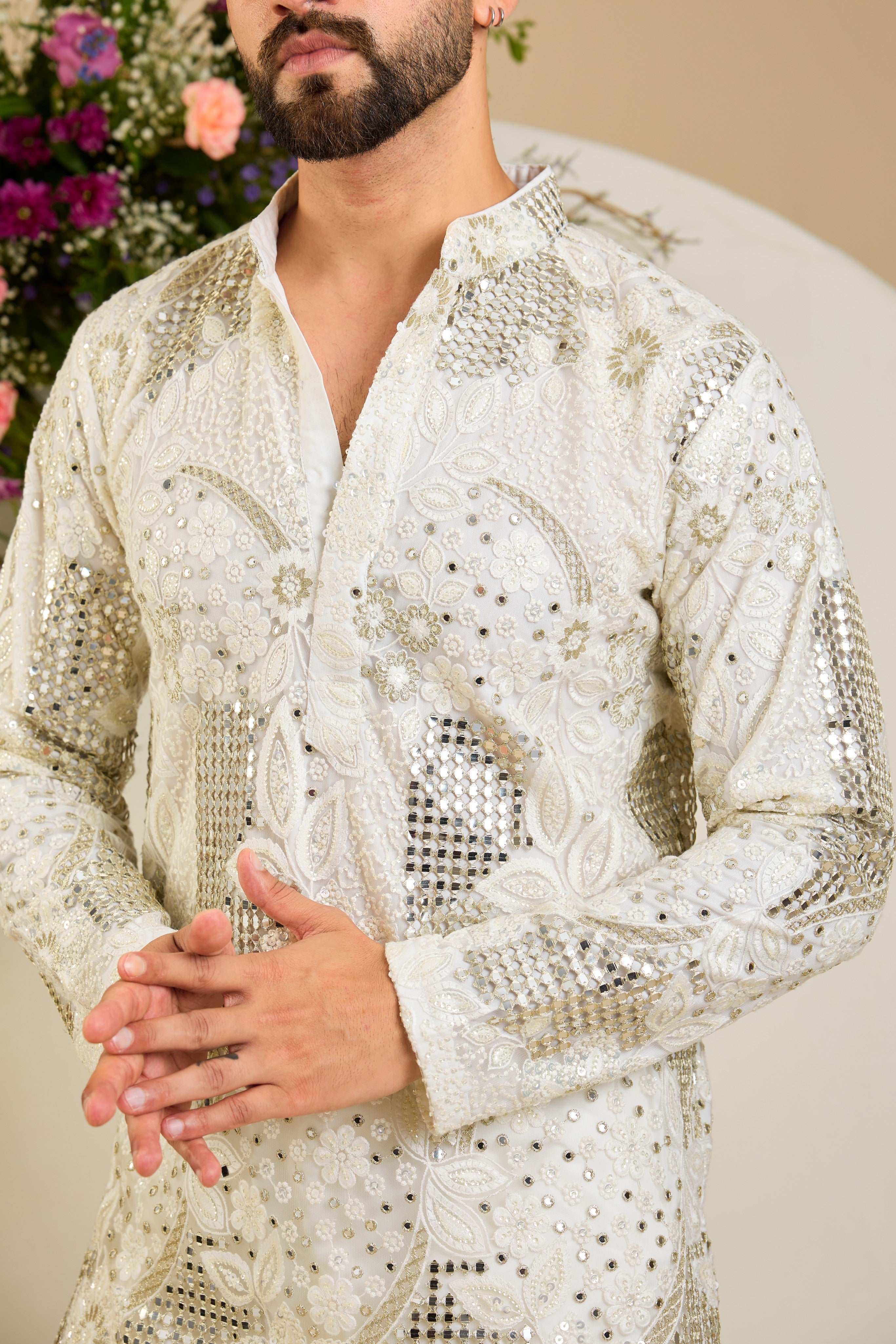 Ivory white mirror work kurta with intricate floral embroidery and refined zari detailing for timeless occasion elegance.