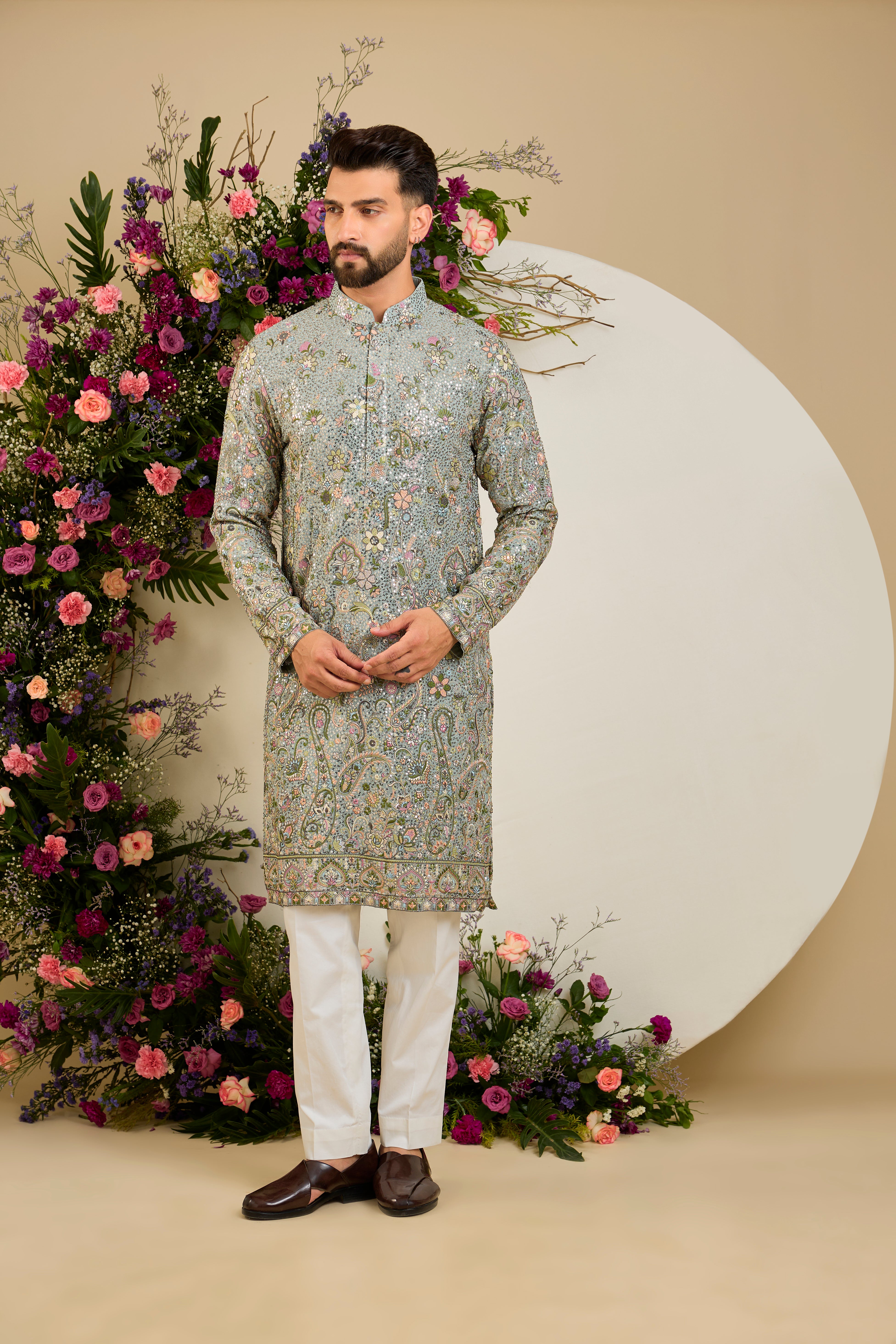 Heavy sequined aqua blue shaded kurta with intricate multi-coloured thread embroidery, tailored for distinguished celebrations and timeless elegance.