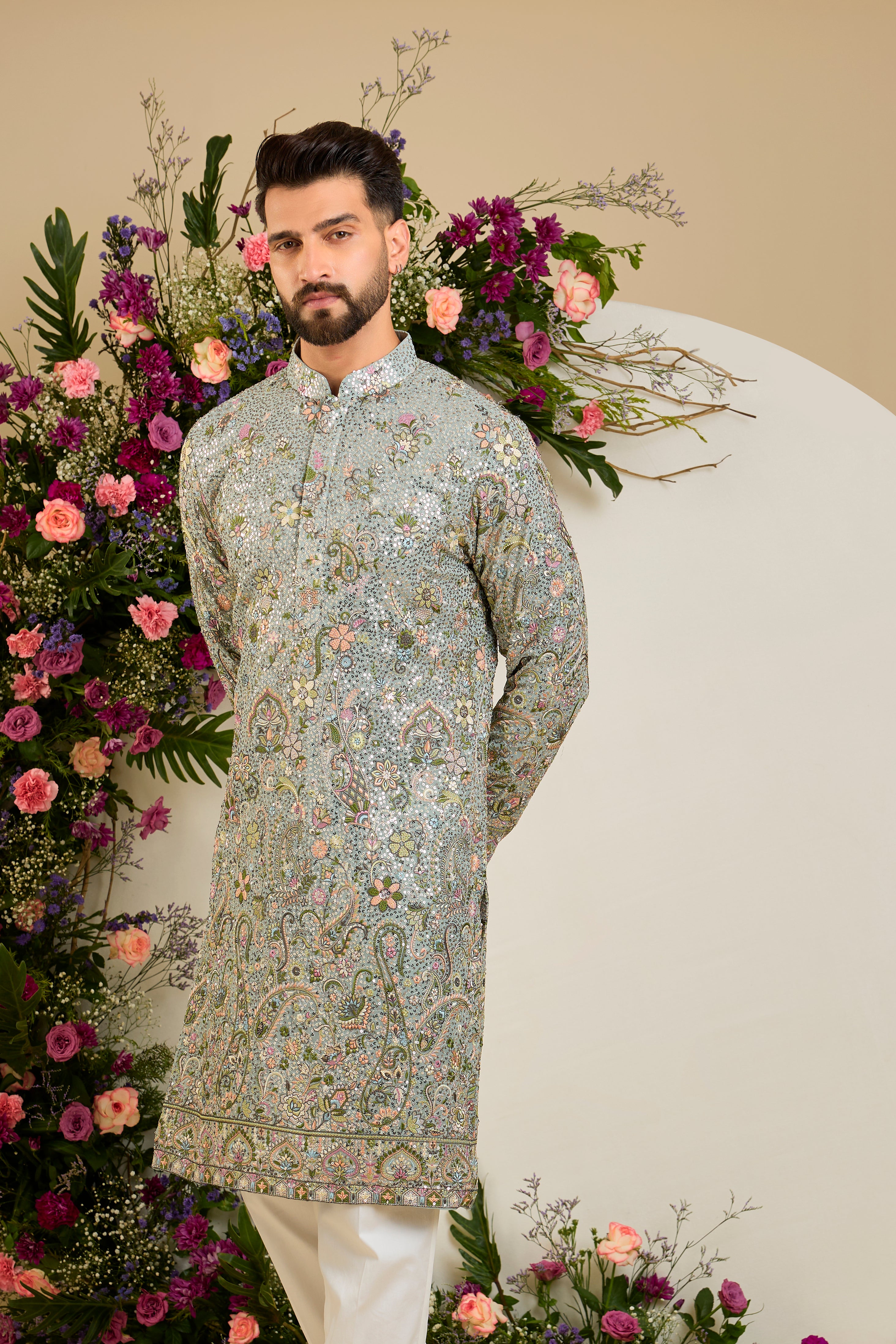 Heavy sequined aqua blue shaded kurta with intricate multi-coloured thread embroidery, tailored for distinguished celebrations and timeless elegance.