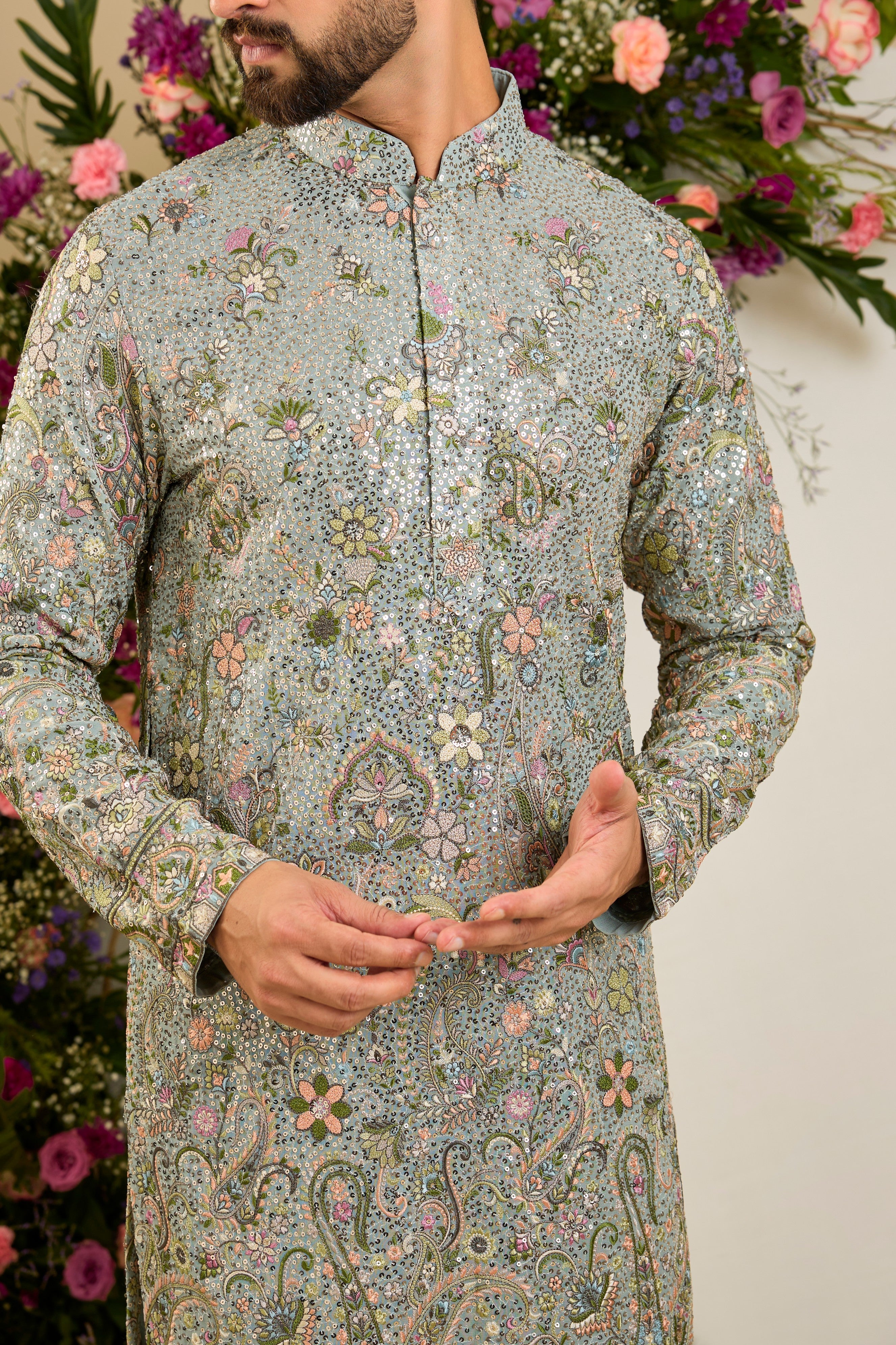 Heavy sequined aqua blue shaded kurta with intricate multi-coloured thread embroidery, tailored for distinguished celebrations and timeless elegance.