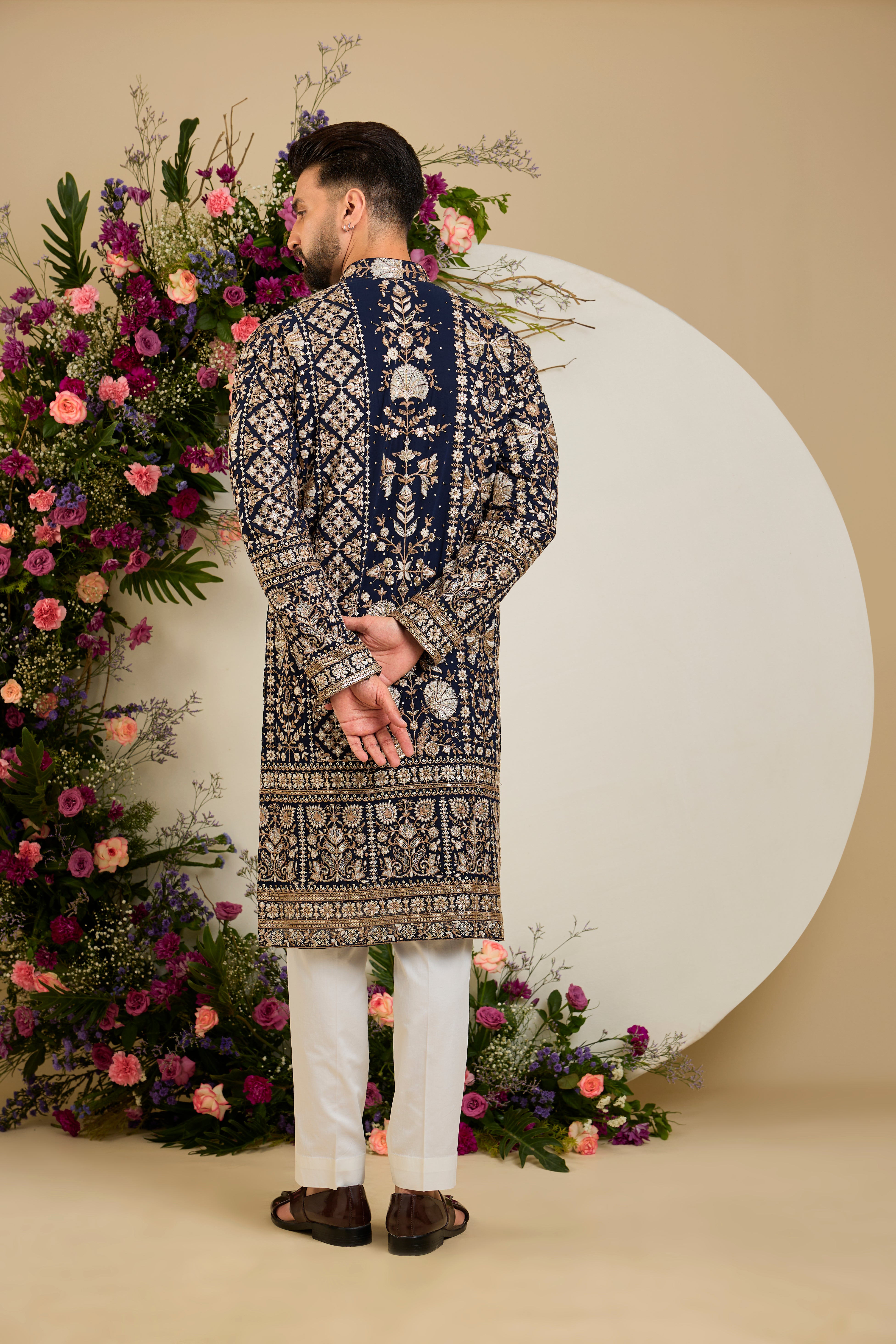 Navy blue floral kurta with intricate sequin and zari detailing, tailored for timeless elegance and distinguished celebrations.