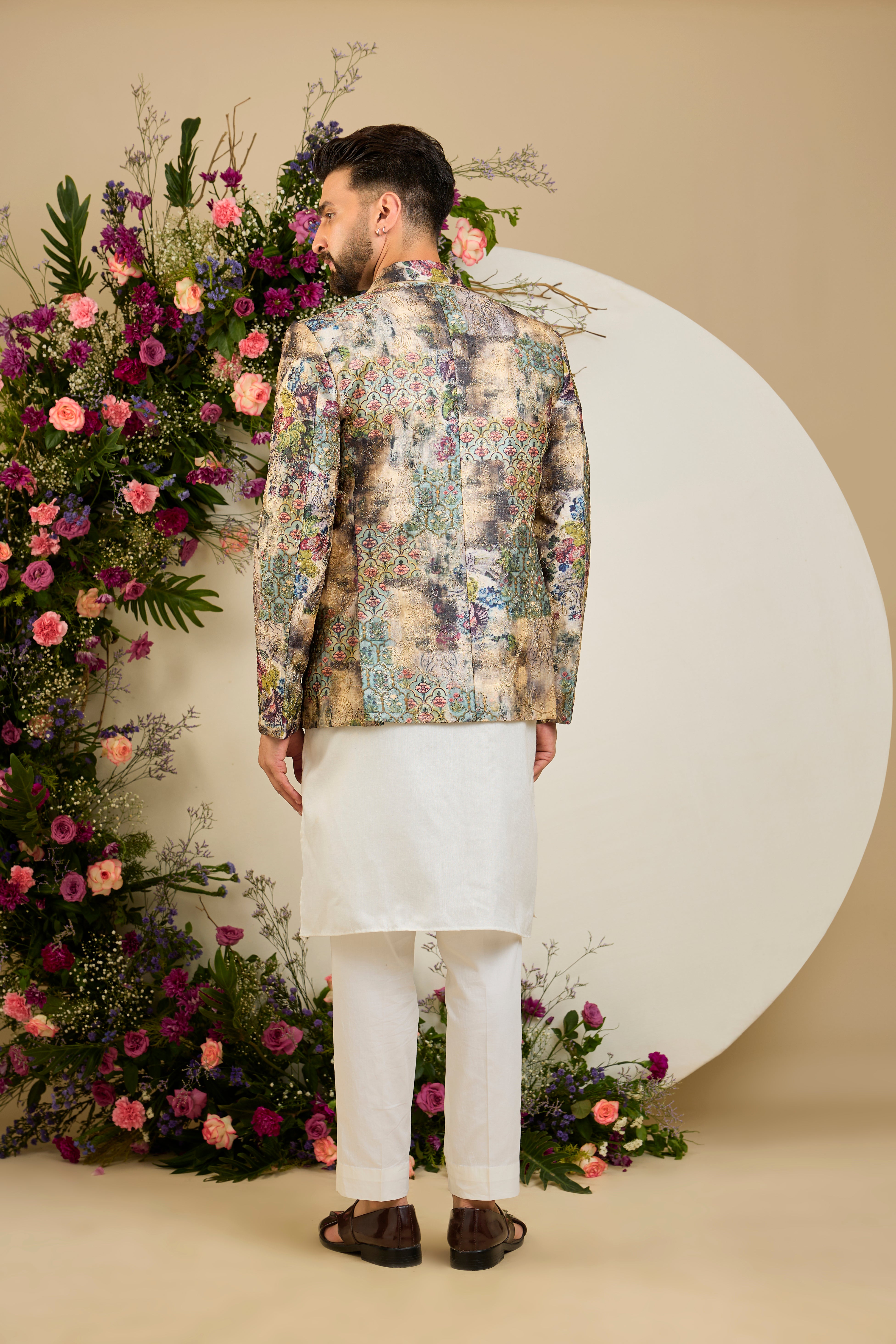 Showcasing a vibrant multi-coloured floral backdrop, this blazer is elevated with refined aari craftsmanship .An exceptional expression of contemporary couture and timeless elegance.