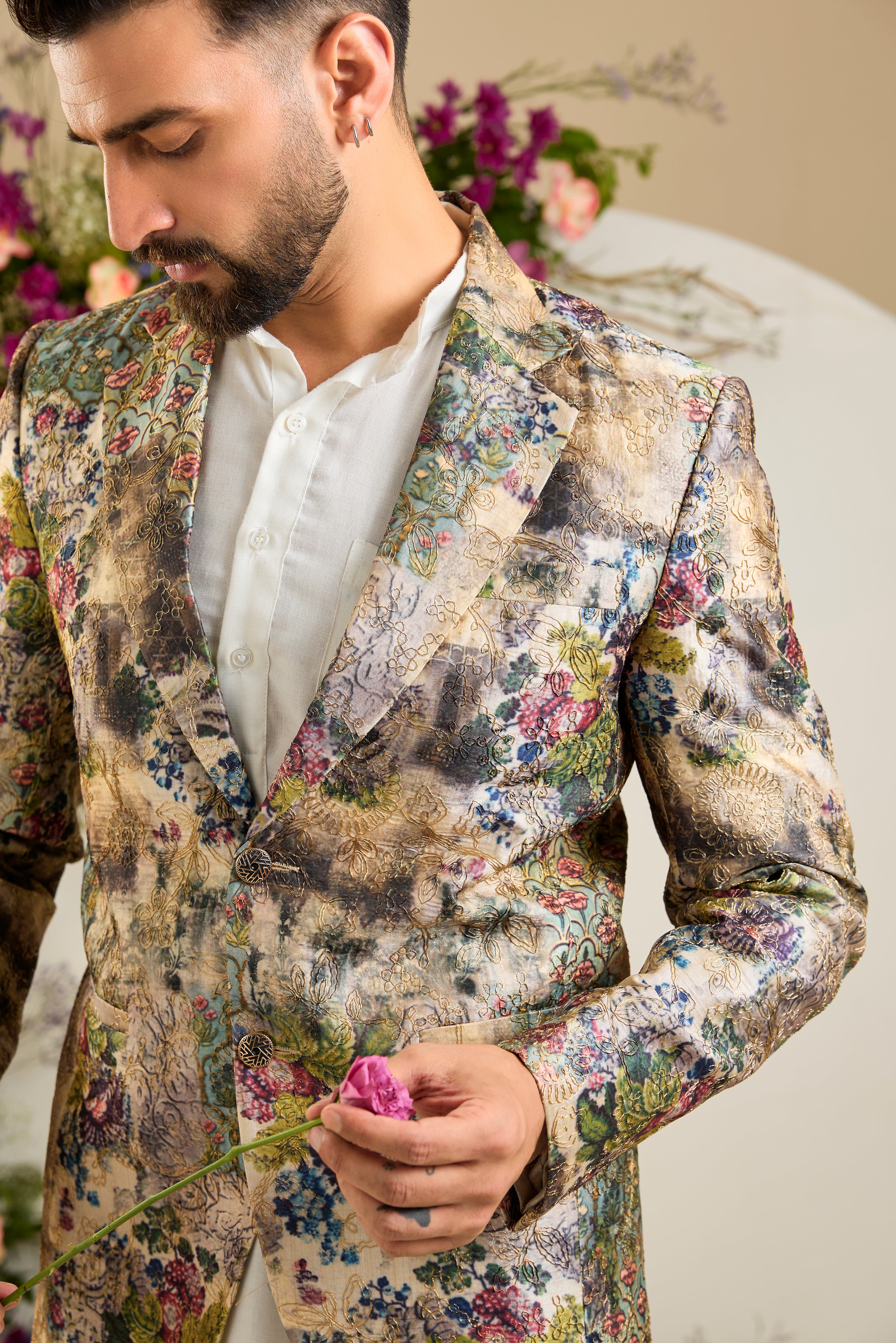 Showcasing a vibrant multi-coloured floral backdrop, this blazer is elevated with refined aari craftsmanship .An exceptional expression of contemporary couture and timeless elegance.