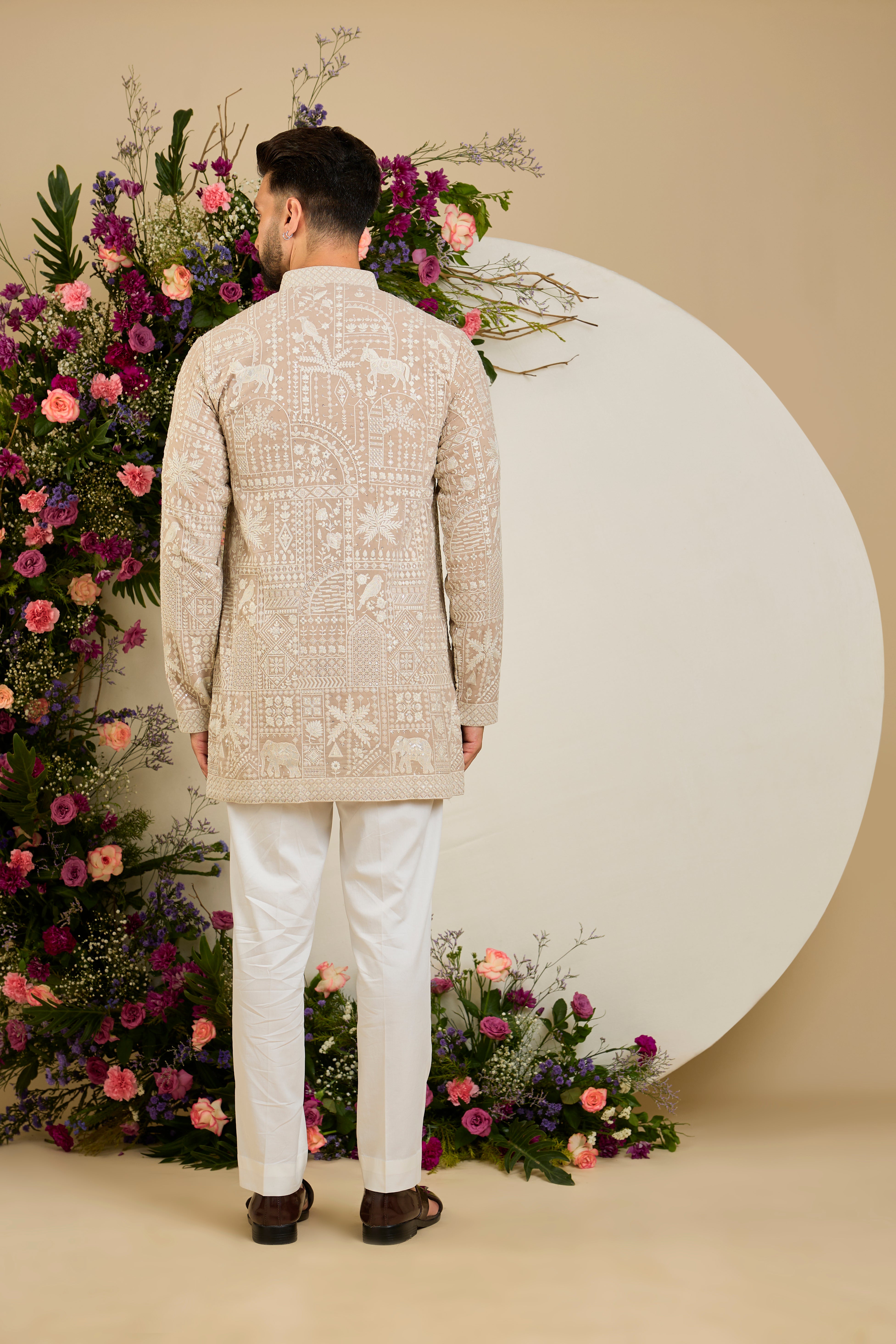 Light beige- mouse short kurta with flora and fauna embroidery, an embellished neckline, ivory threadwork, and delicate sequin detailing.