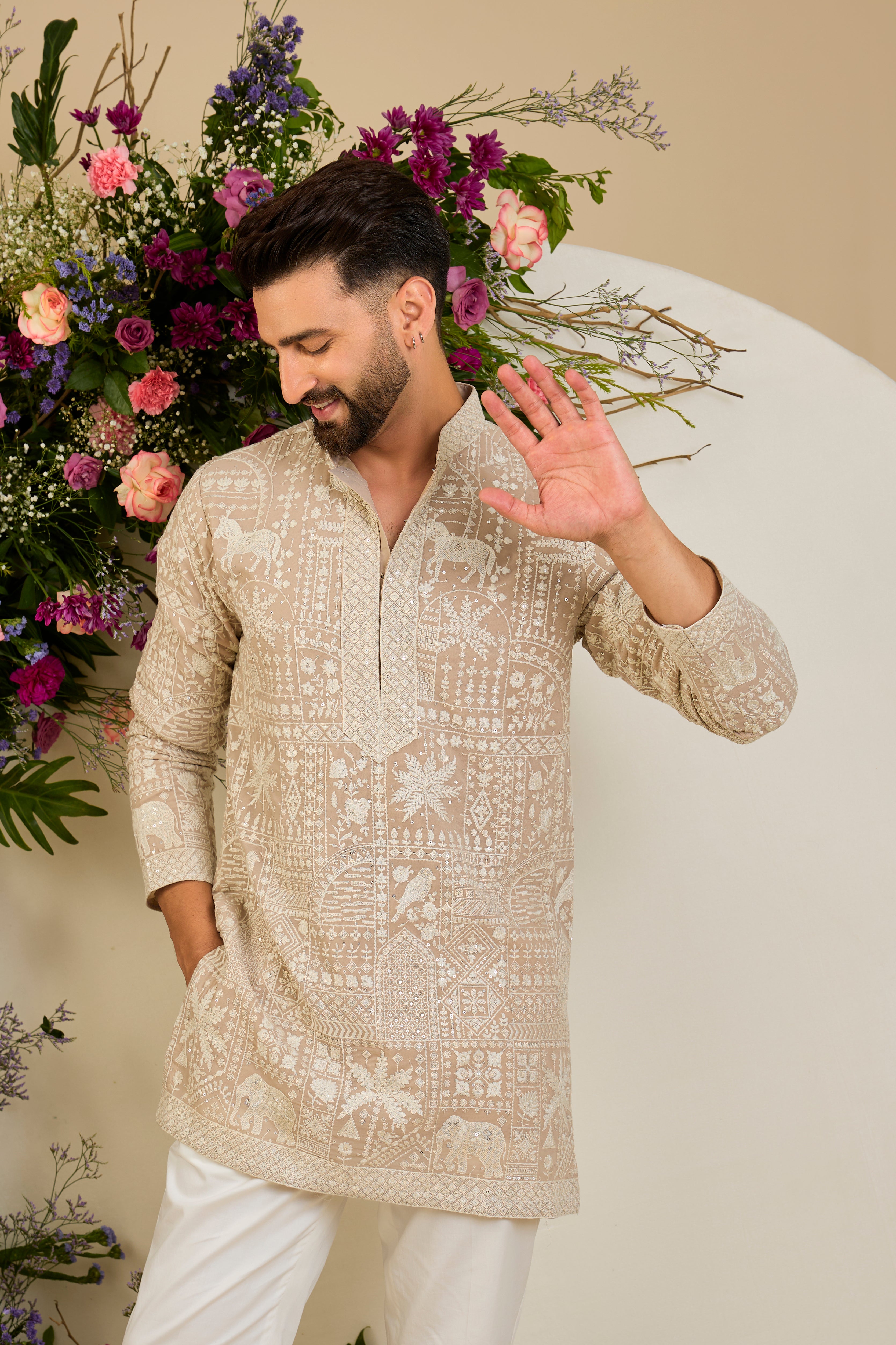 Light beige- mouse short kurta with flora and fauna embroidery, an embellished neckline, ivory threadwork, and delicate sequin detailing.