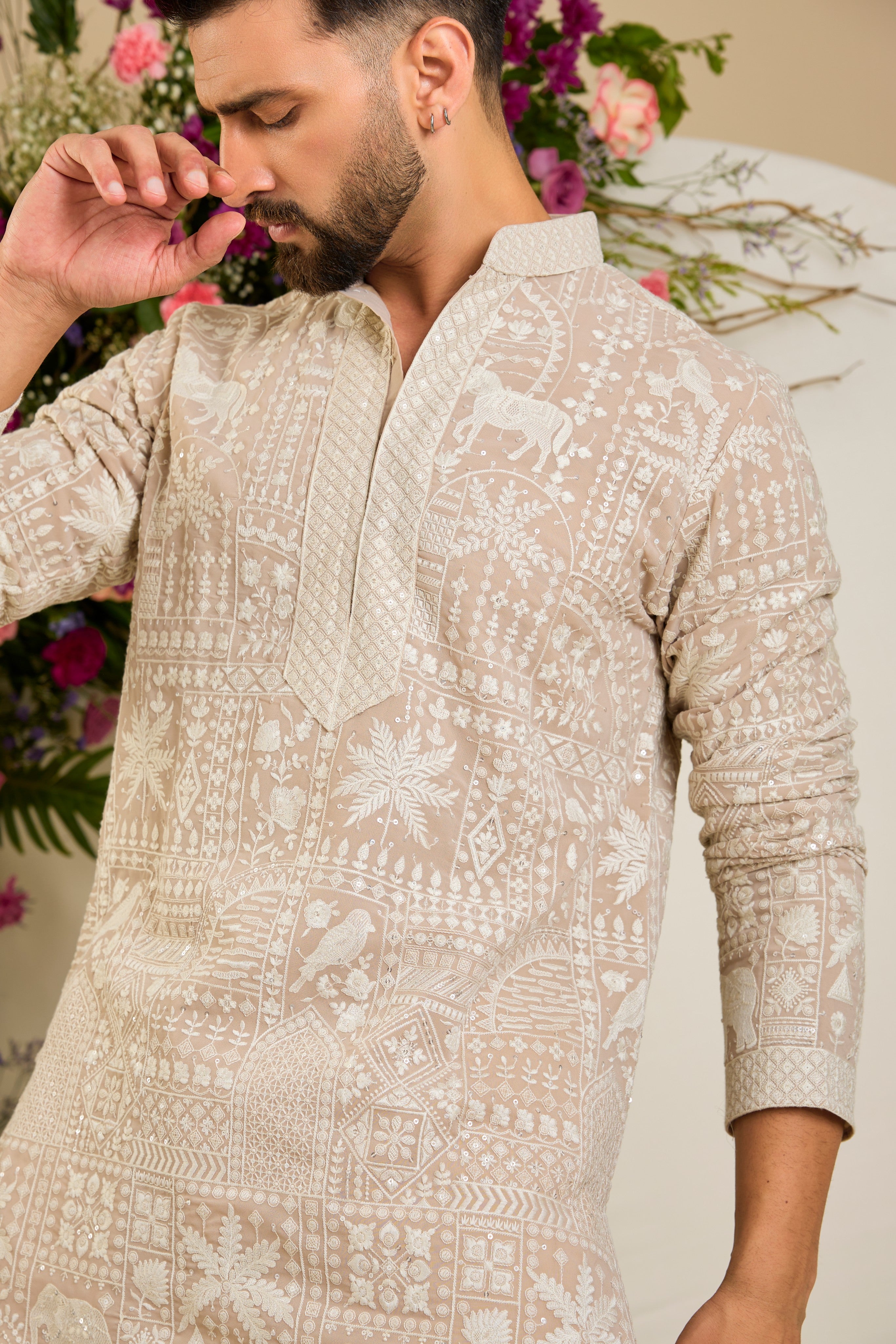 Light beige- mouse short kurta with flora and fauna embroidery, an embellished neckline, ivory threadwork, and delicate sequin detailing.