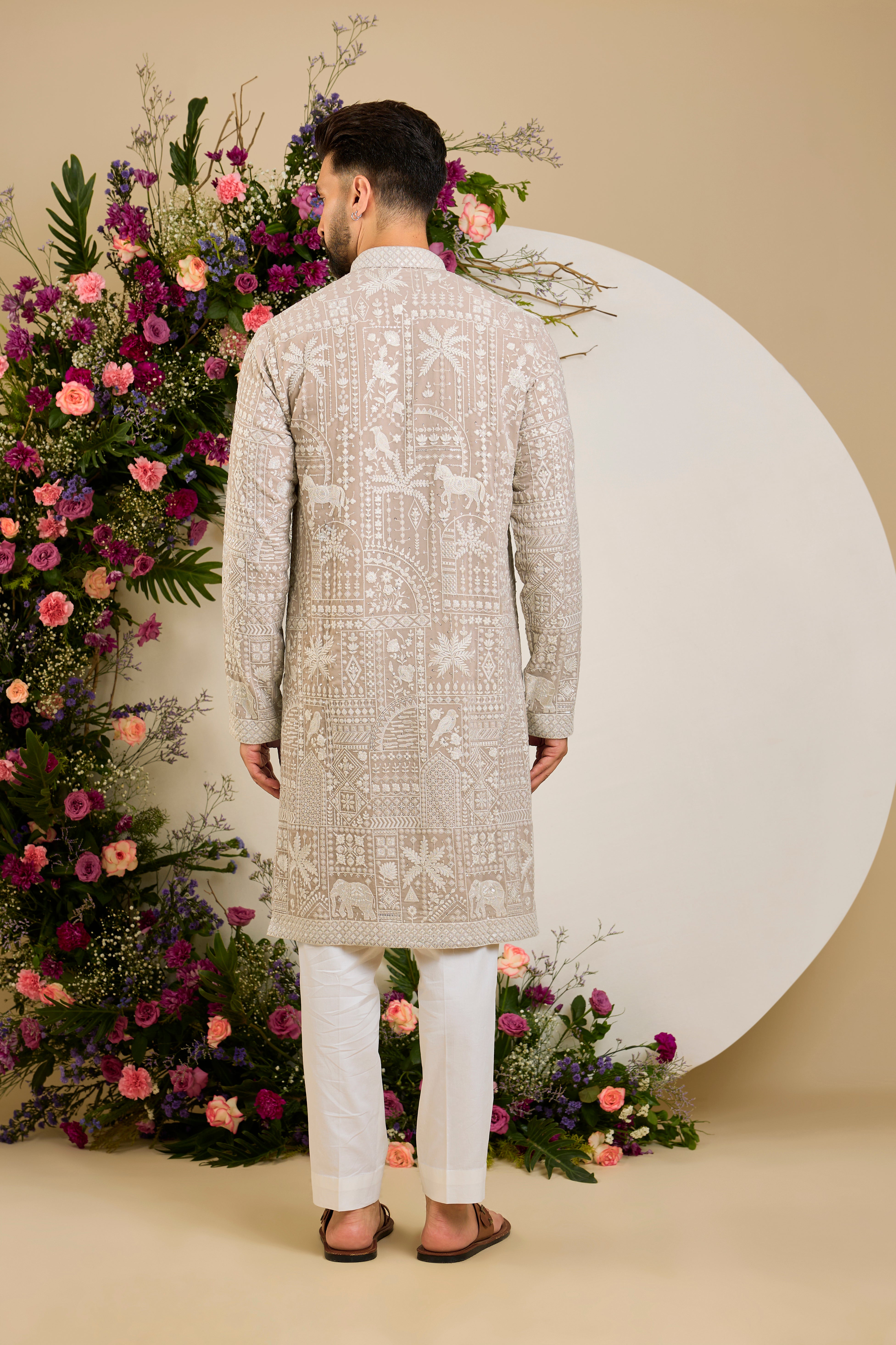 Light beige- mouse kurta with flora and fauna embroidery, an embellished neckline, ivory threadwork, and delicate sequin detailing.