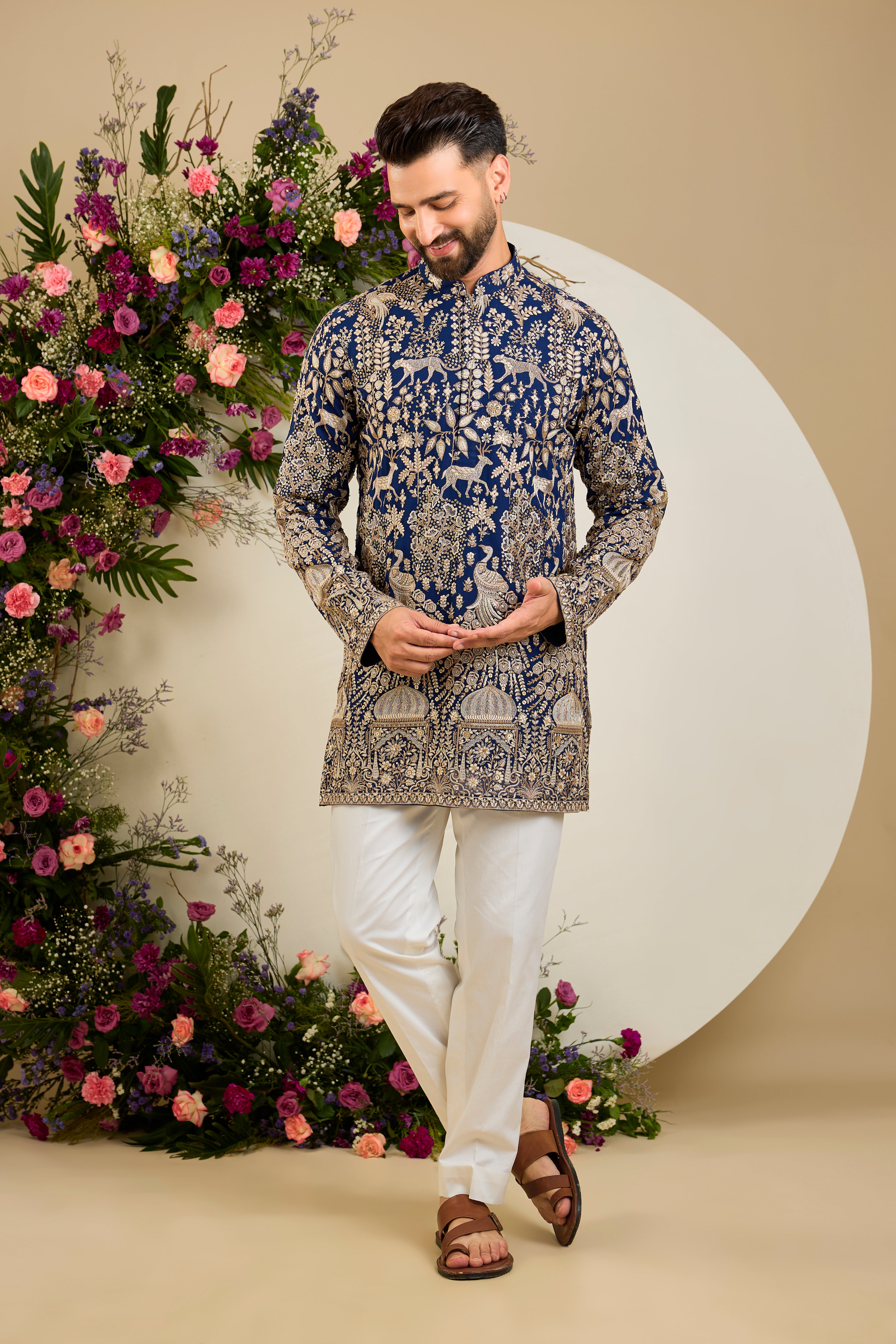 Royal blue heritage short kurta with Mughal domes, peacocks, lions, heavy zari embroidery, and refined sequin detailing.