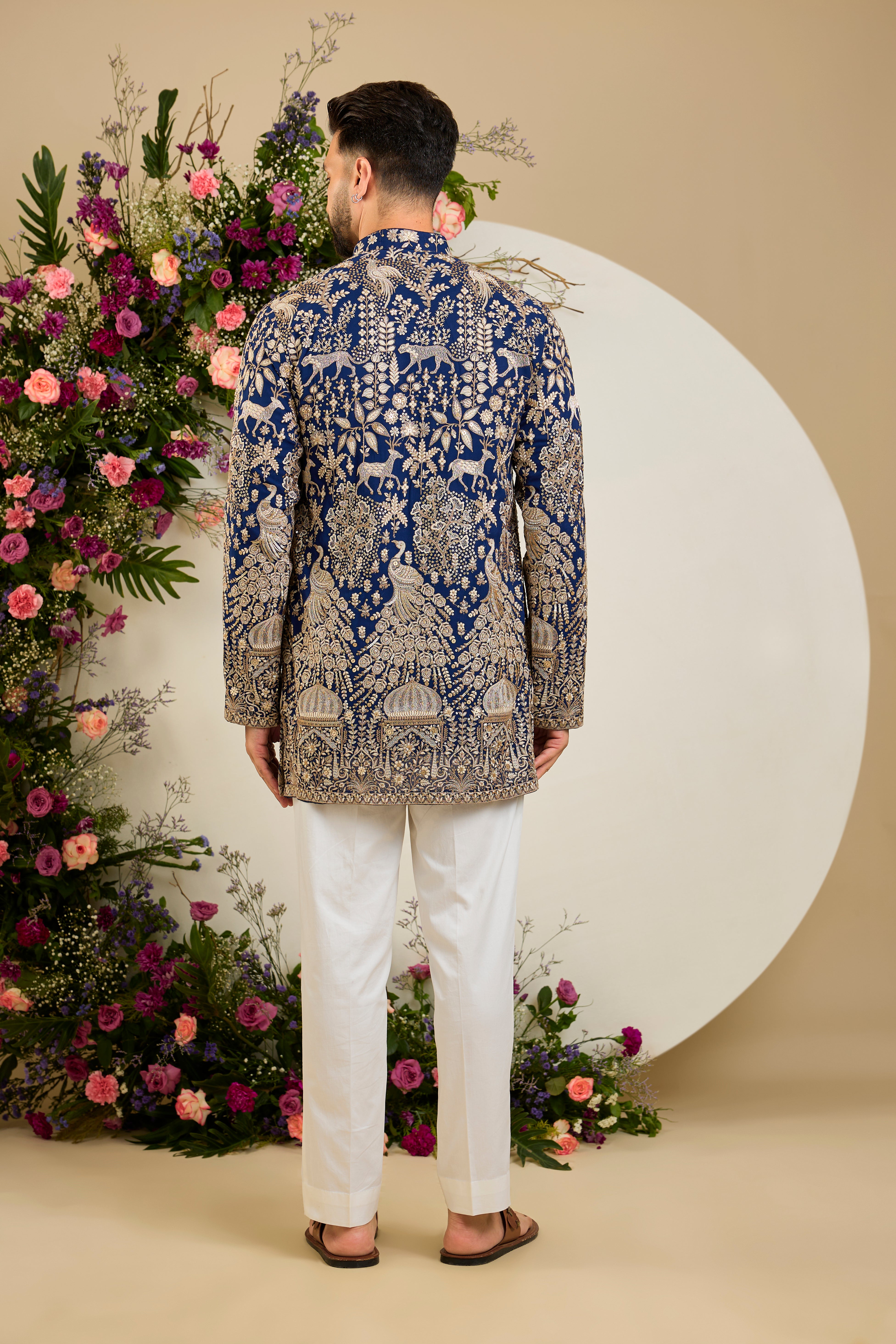 Royal blue heritage short kurta with Mughal domes, peacocks, lions, heavy zari embroidery, and refined sequin detailing.