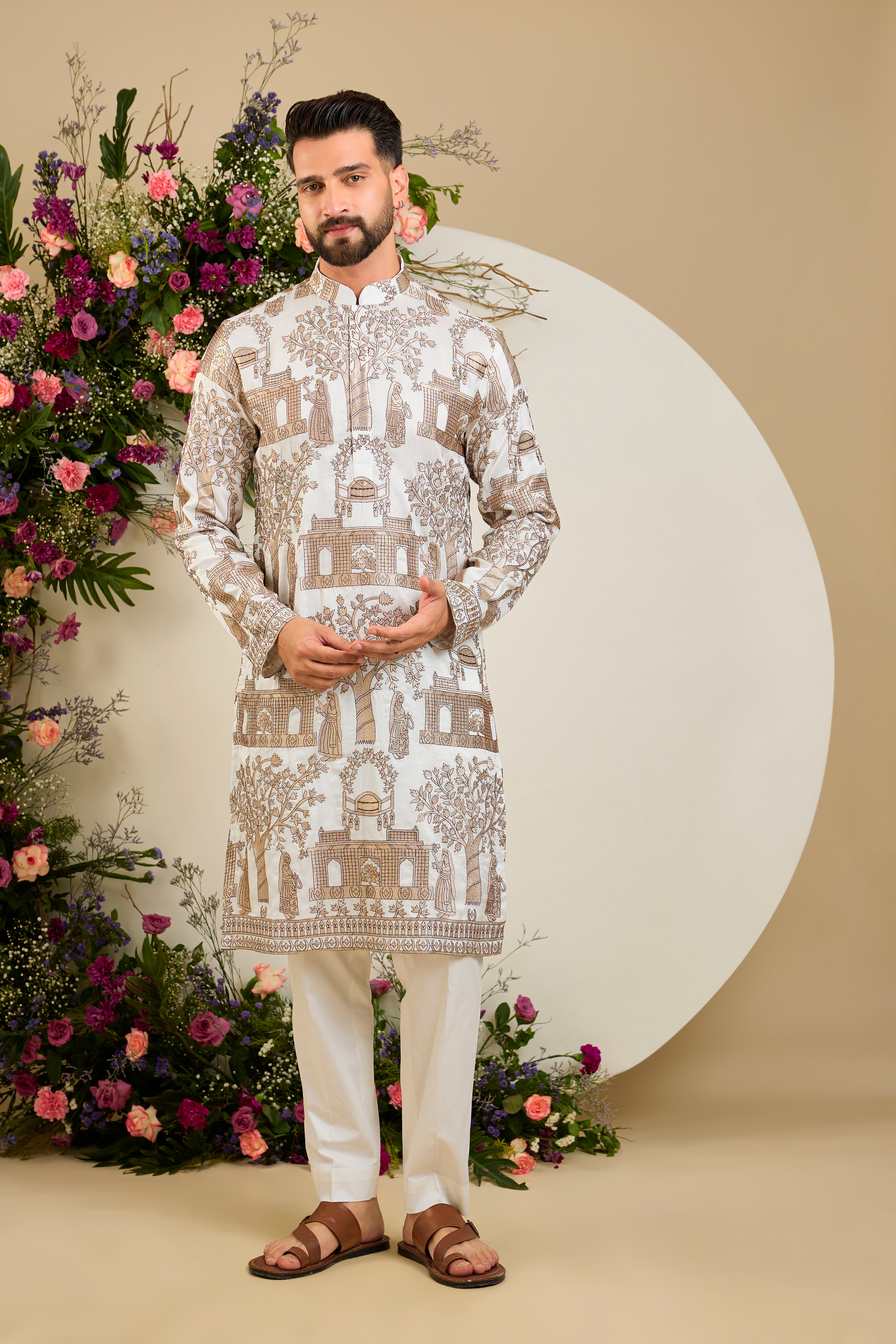 Ivory white silk kurta with intricate Mughal-inspired zari embroidery, celebrating the grandeur and artistry of a royal legacy.