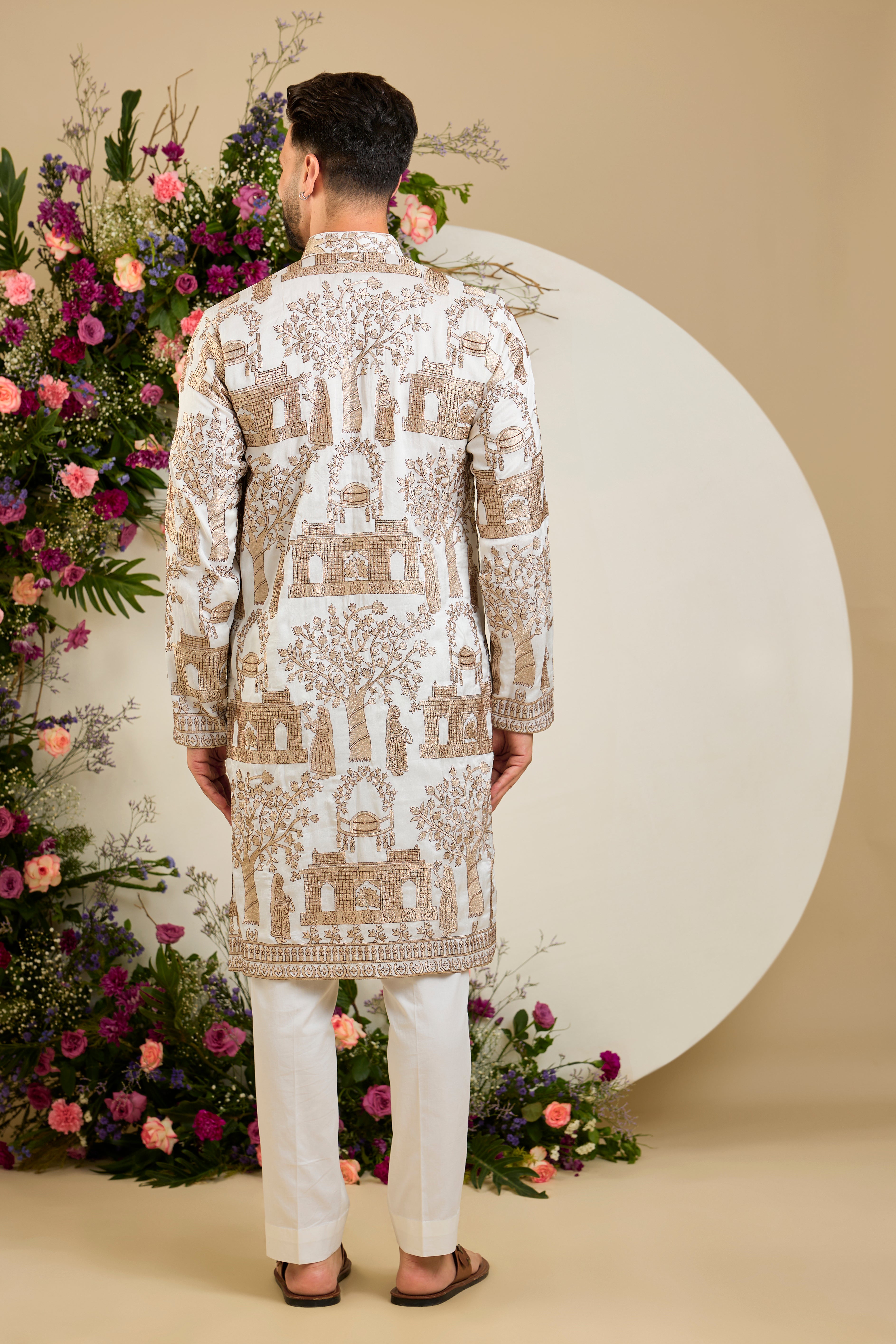 Ivory white silk kurta with intricate Mughal-inspired zari embroidery, celebrating the grandeur and artistry of a royal legacy.