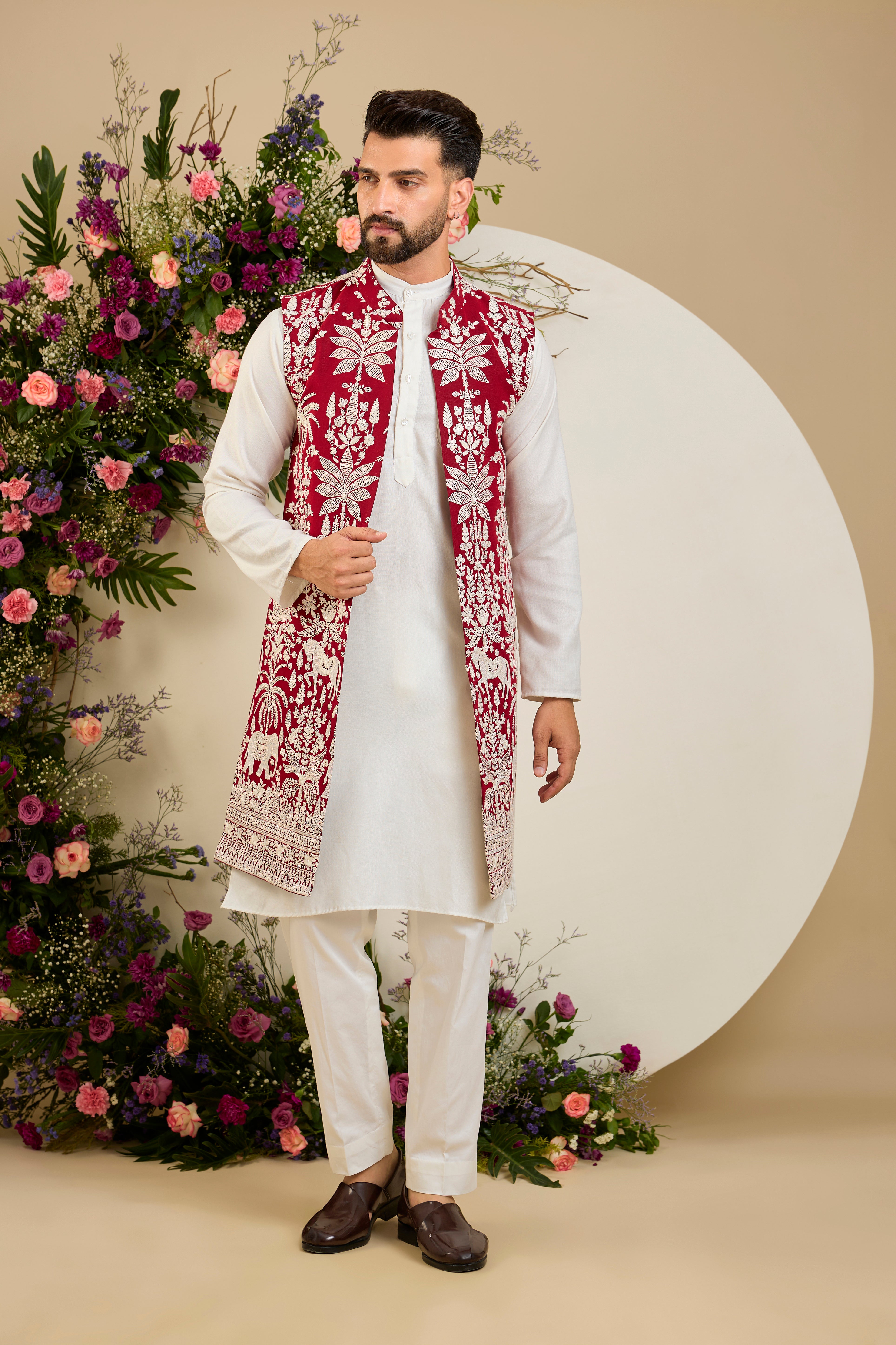 Red long open jacket with tropical flora and fauna embroidery, ivory threadwork, and delicate sequin detailing for refined occasion wear.