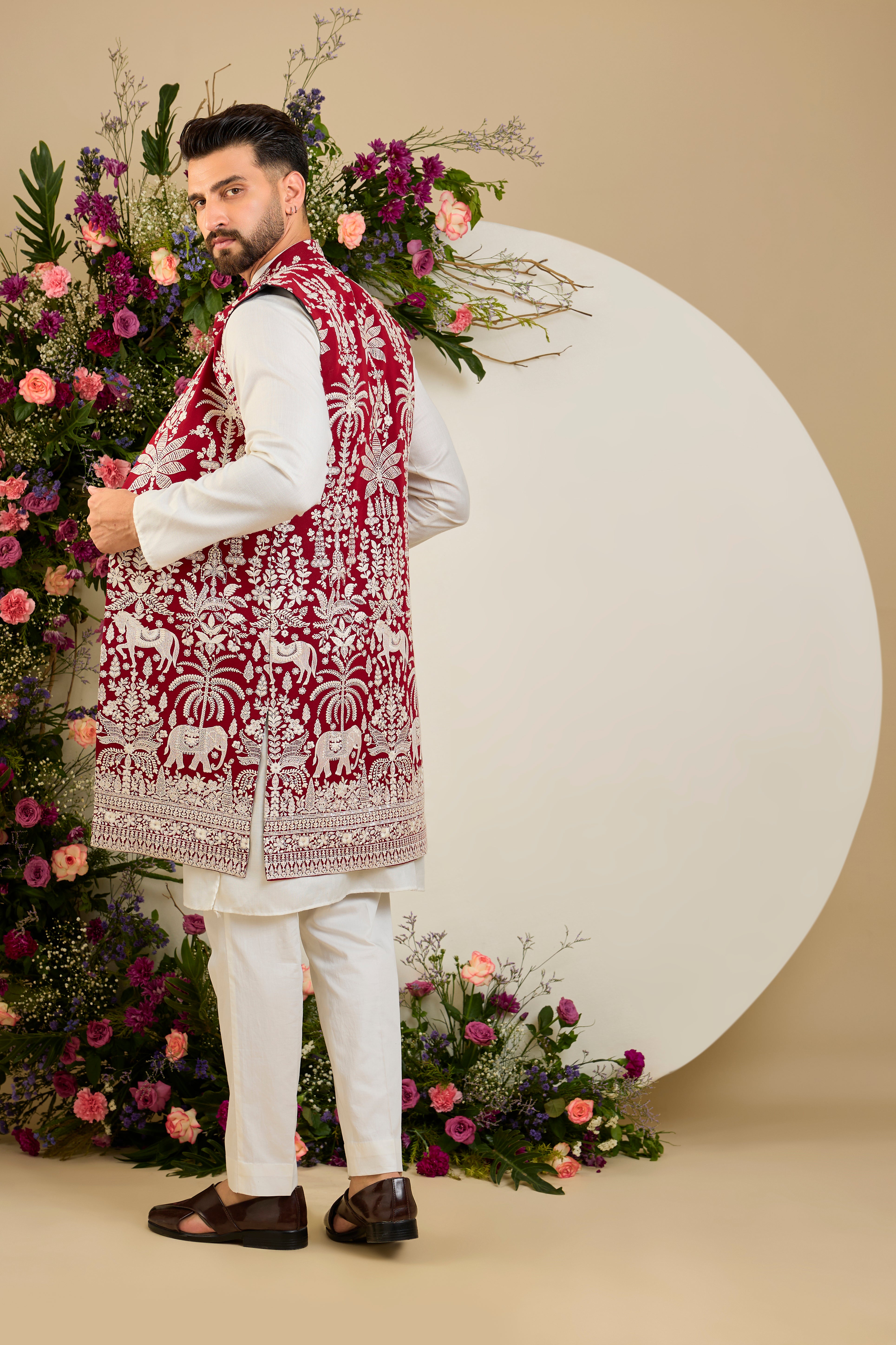 Red long open jacket with tropical flora and fauna embroidery, ivory threadwork, and delicate sequin detailing for refined occasion wear.