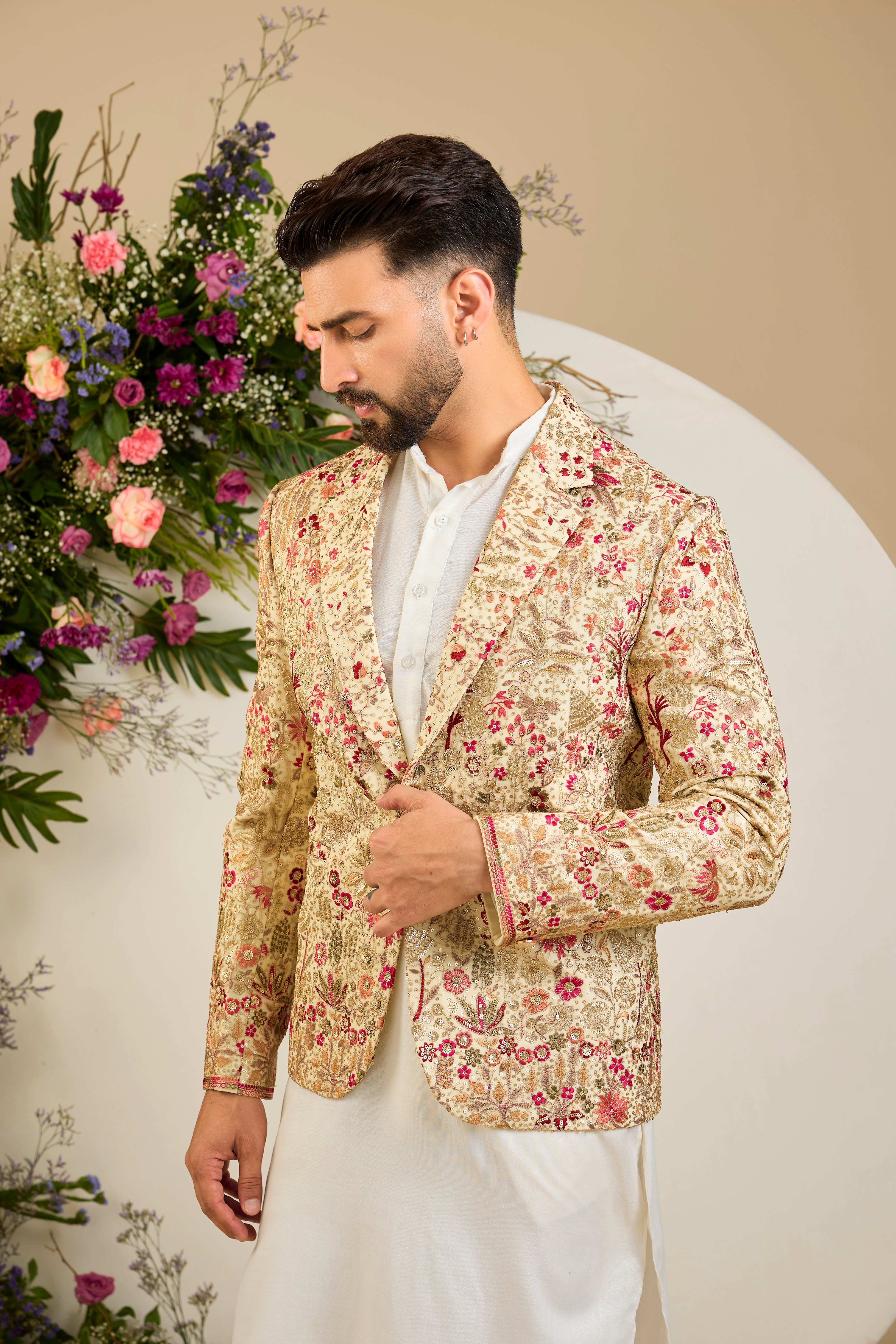 Cream gold blazer with floral embroidery, zari work, multi-coloured thread detailing, and refined sequin embellishments for elevated occasion wear.