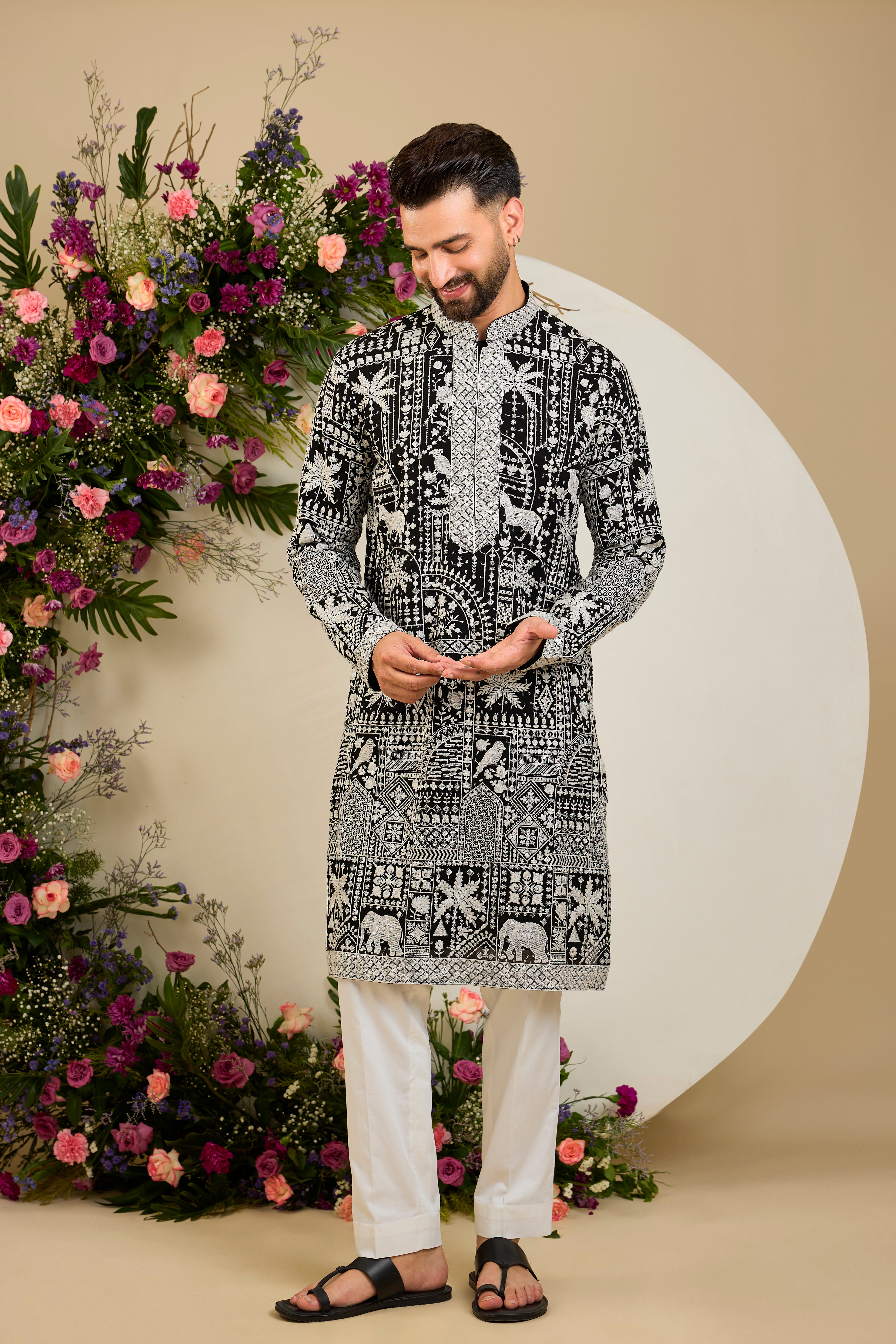 Black kurta with flora and fauna embroidery, an embellished neckline, ivory threadwork, and delicate sequin detailing.