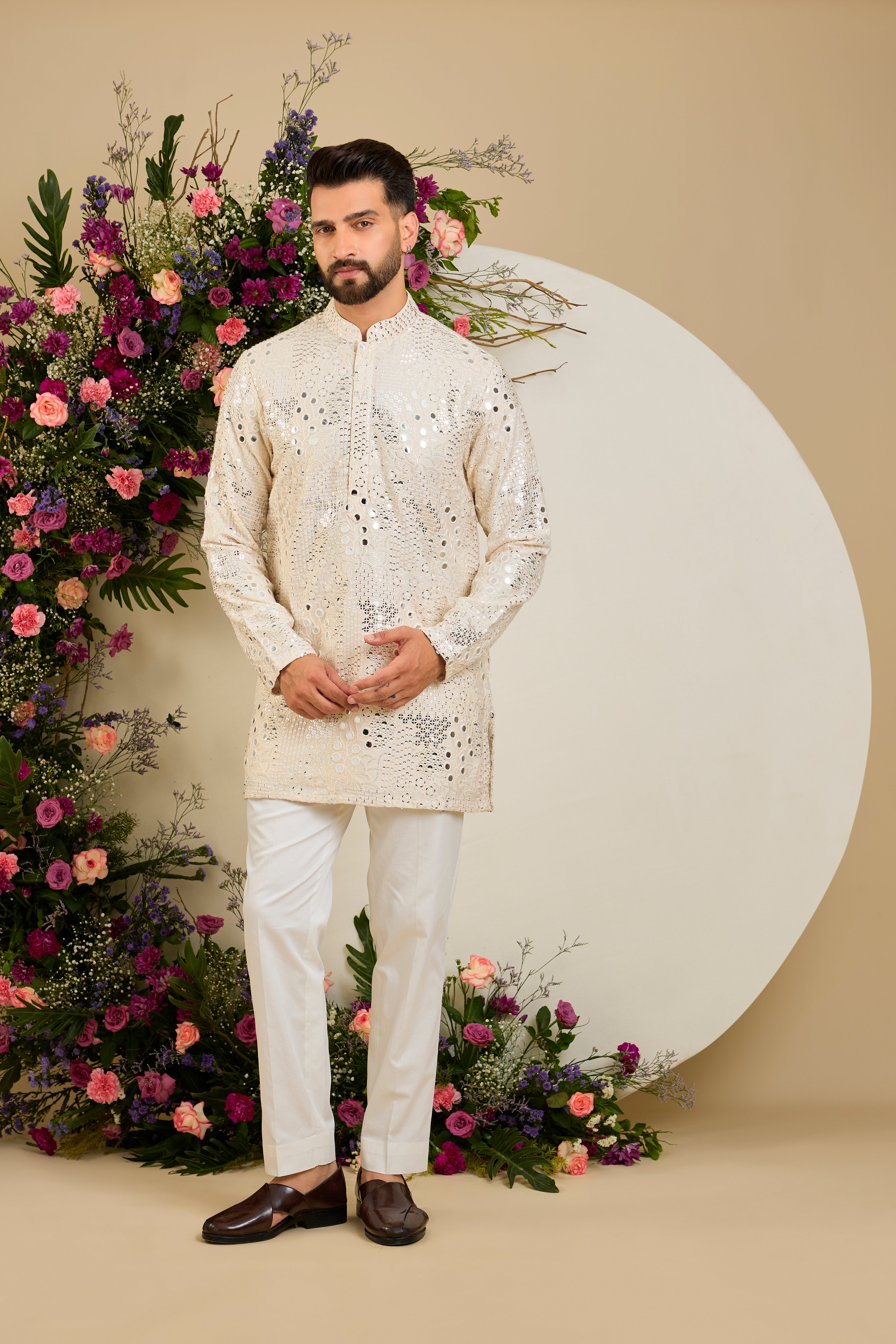 Cream short mirror work kurta with intricate embroidery, and delicate sequin detailing for timeless sophistication.
