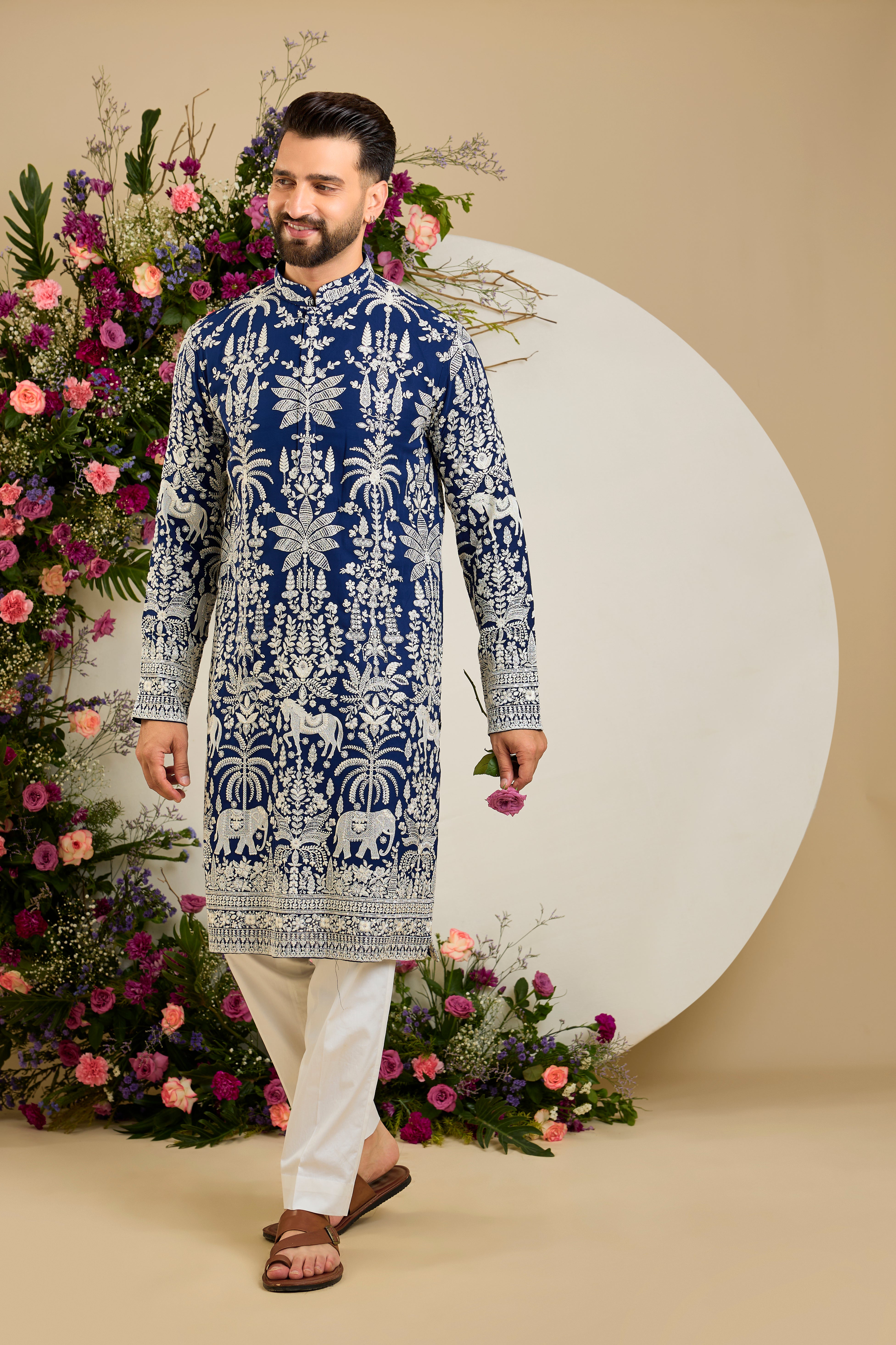 Royal blue kurta with tropical flora and fauna embroidery, ivory threadwork, and delicate sequin detailing for refined occasion wear.