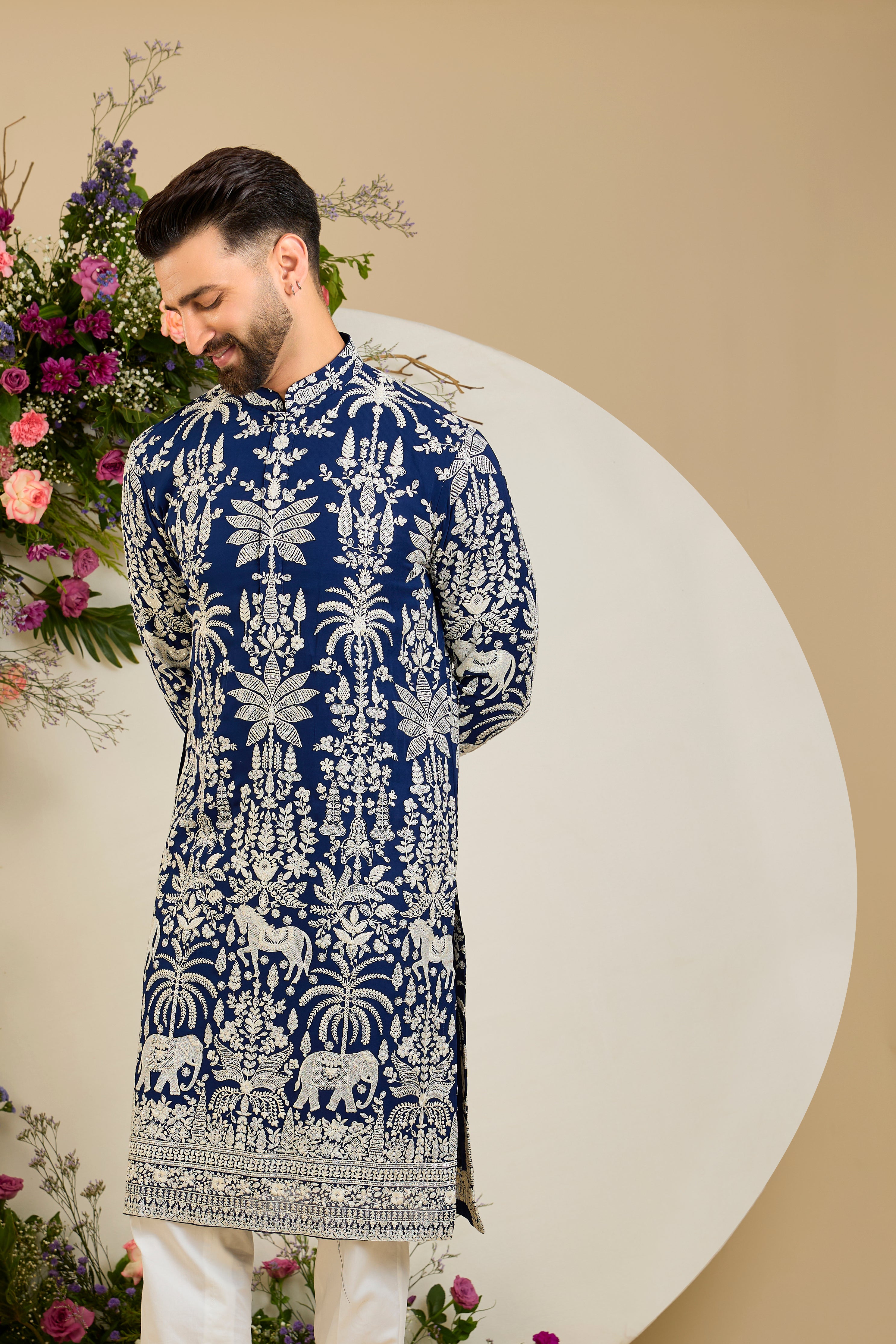 Royal blue kurta with tropical flora and fauna embroidery, ivory threadwork, and delicate sequin detailing for refined occasion wear.