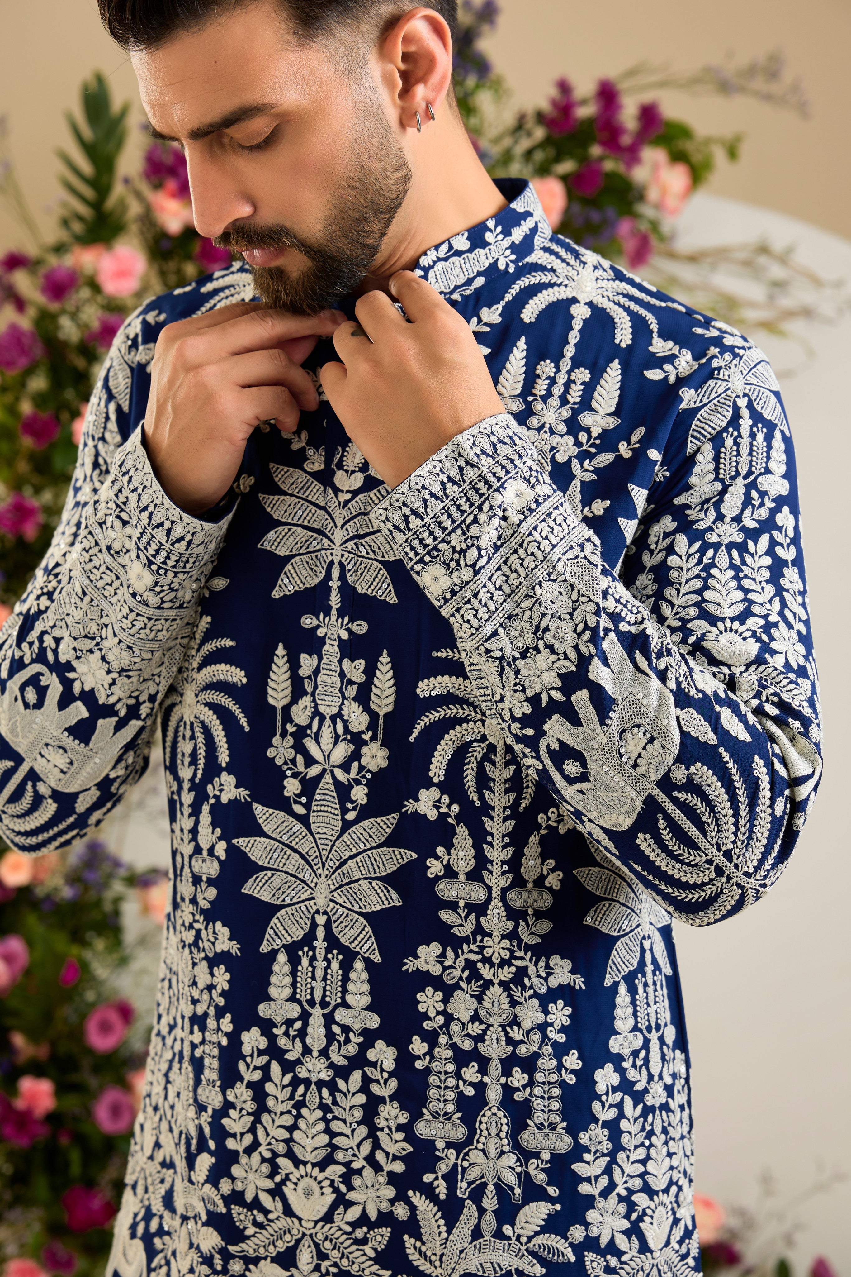 Royal blue kurta with tropical flora and fauna embroidery, ivory threadwork, and delicate sequin detailing for refined occasion wear.