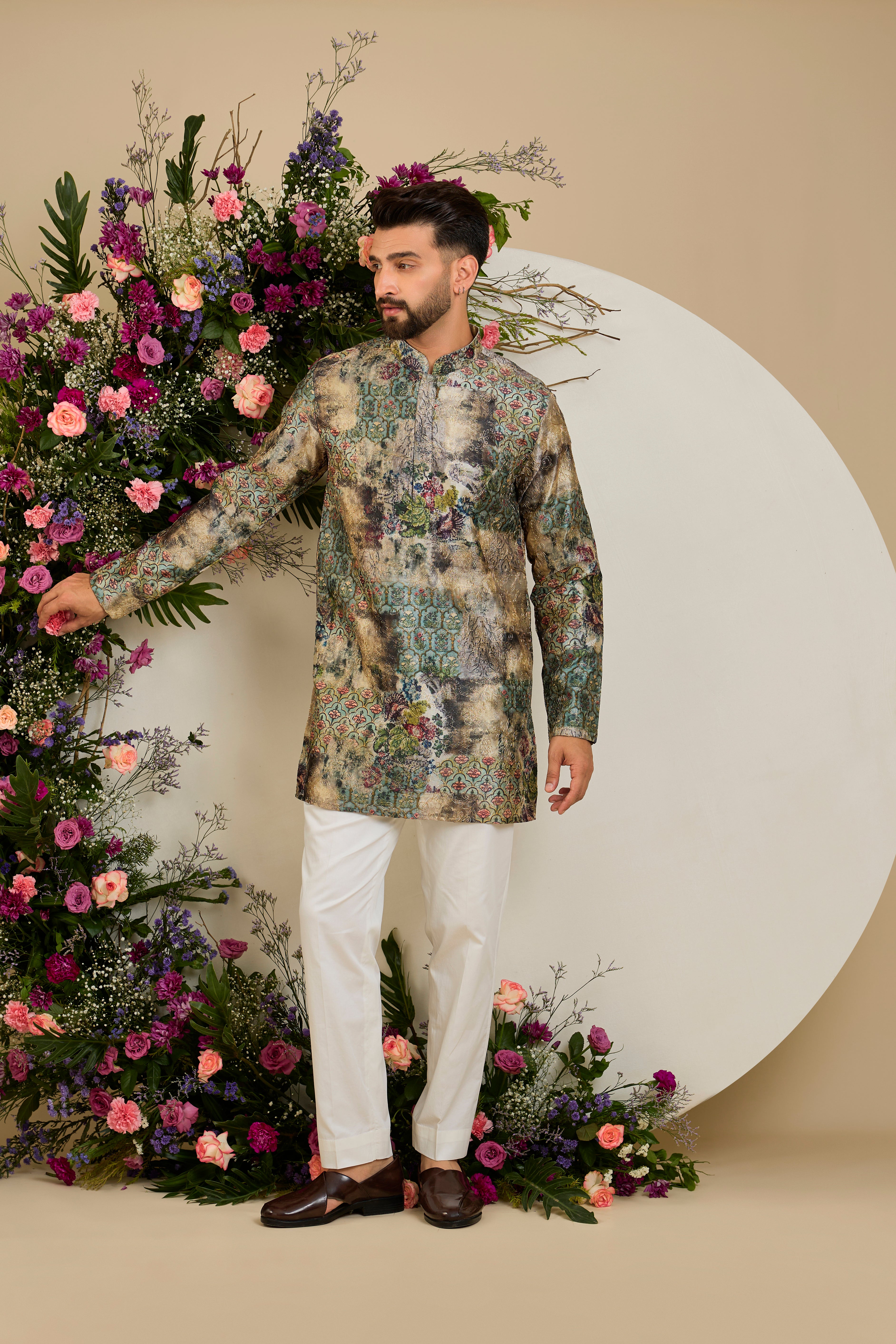 Showcasing a vibrant multi-coloured floral backdrop, this short kurta is elevated with refined aari craftsmanship .An exceptional expression of contemporary couture and timeless elegance.