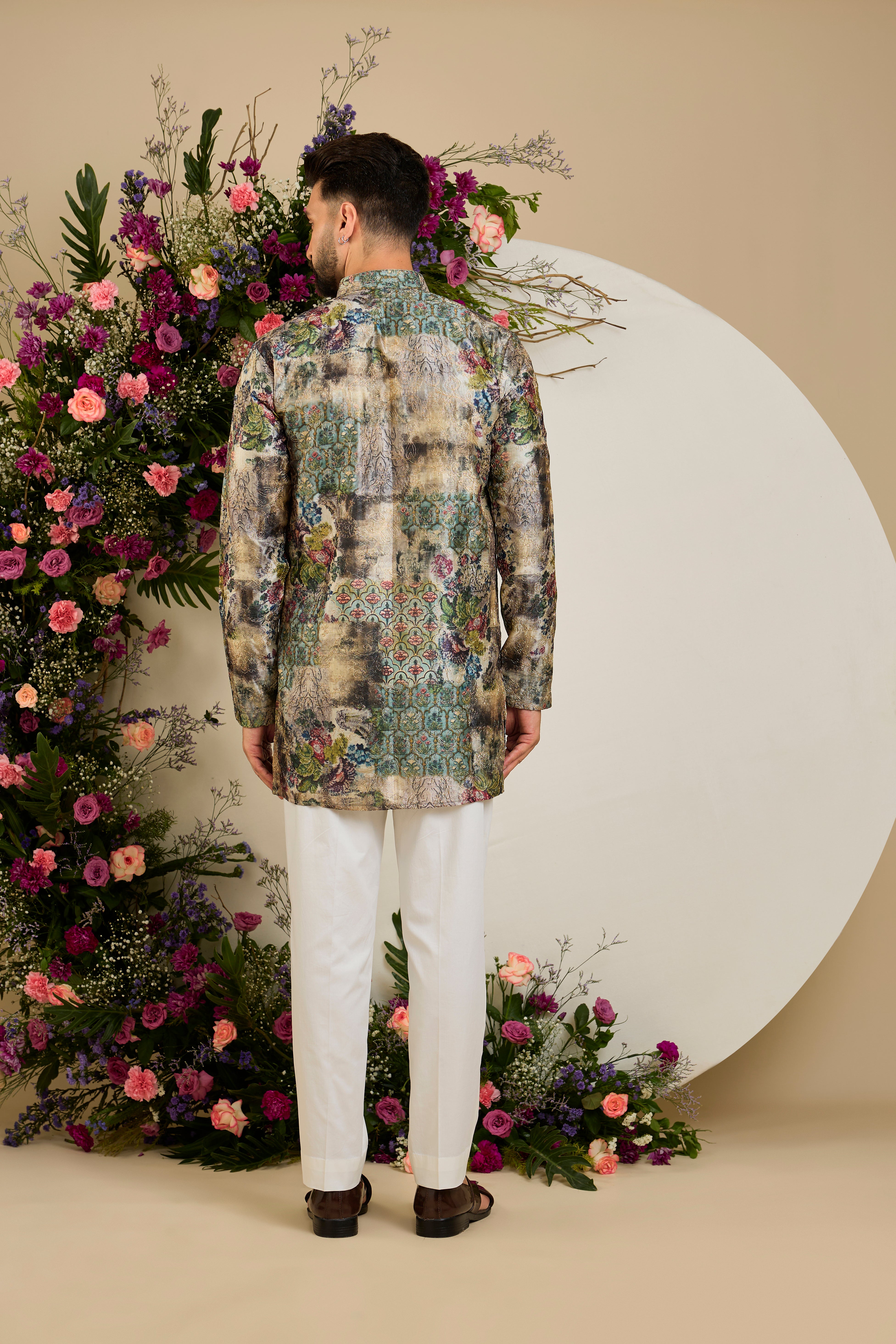 Showcasing a vibrant multi-coloured floral backdrop, this short kurta is elevated with refined aari craftsmanship .An exceptional expression of contemporary couture and timeless elegance.